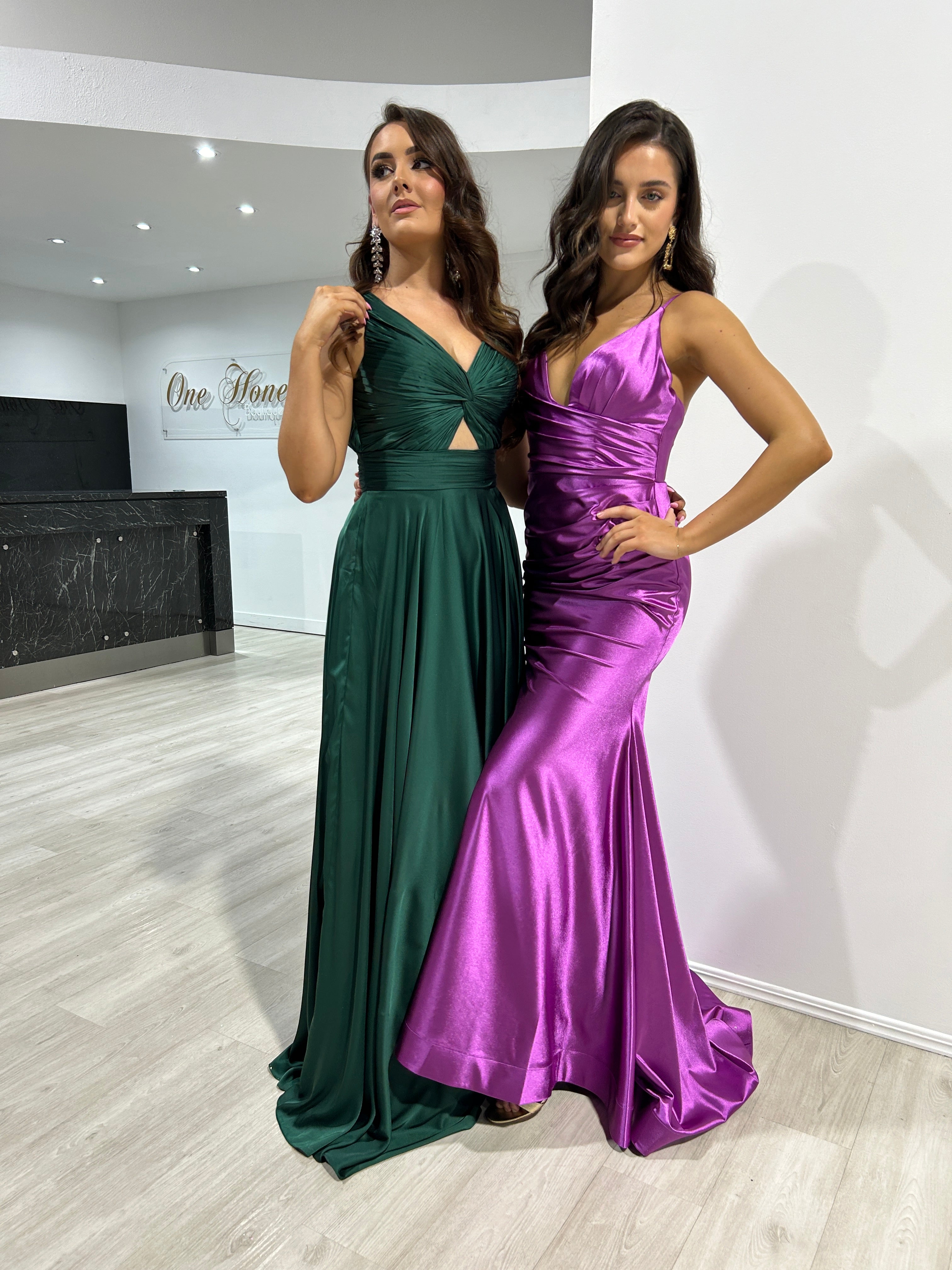 Elegant formal dresses featuring a satin mermaid gown with ruching and a deep green gown with a cutout bodice. Perfect for formal events.