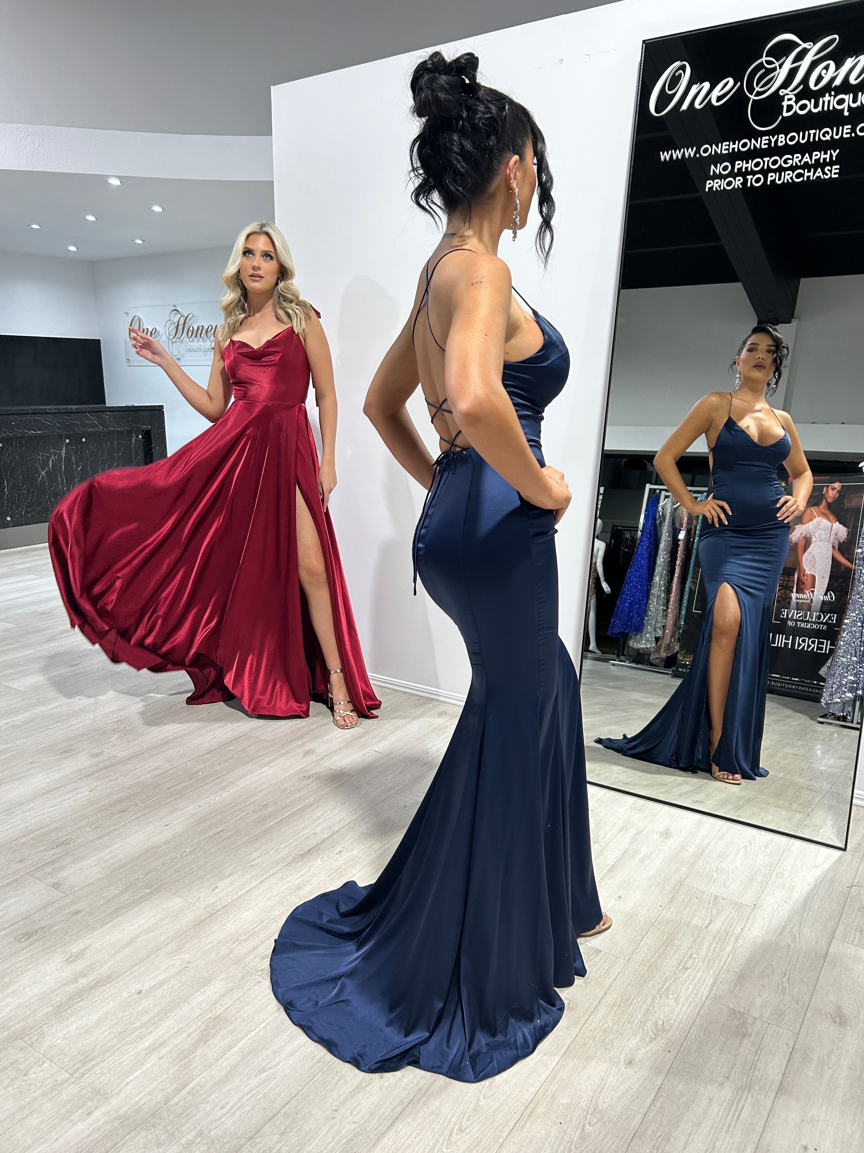 Women wearing elegant silky gowns with spaghetti straps and thigh-high slits, perfect for formal events like prom in Brisbane to Gold Coast.