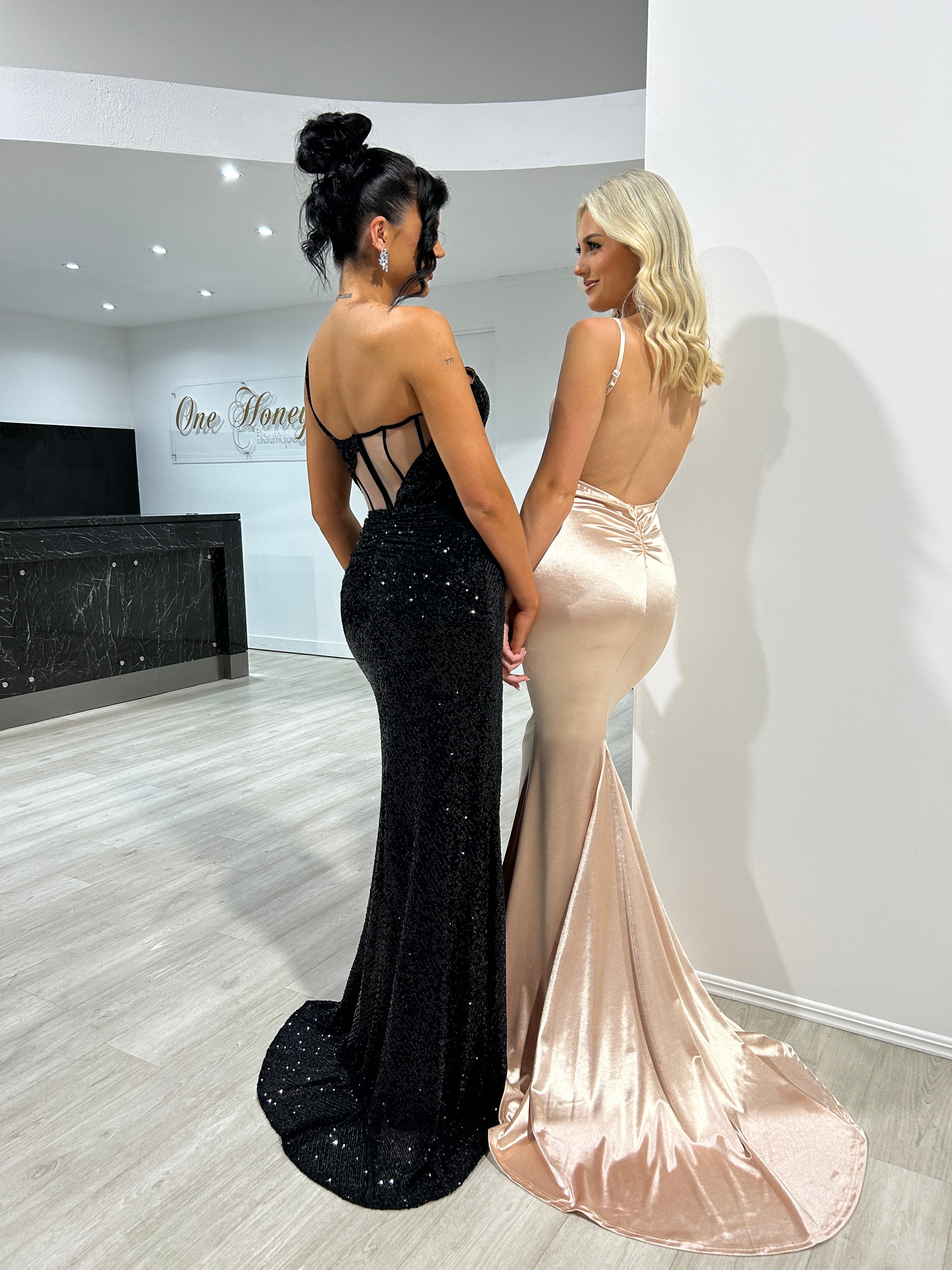Two women in Honey Couture mermaid evening gowns showcasing low back and bum ruching design, perfect for Australian designer prom dresses.