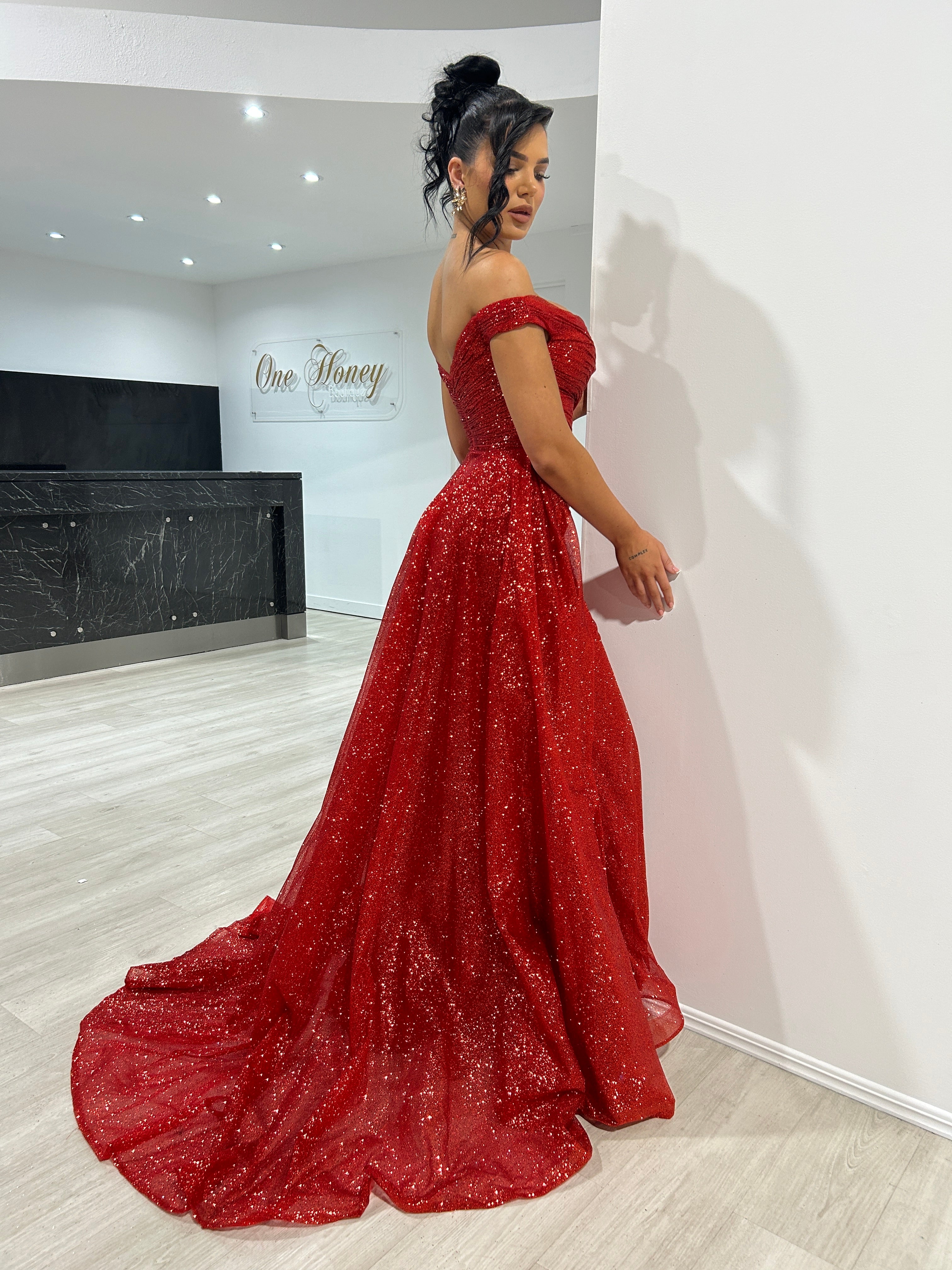 BEBE Glitter Off The Shoulder Overskirt Formal Dress in red glitter fabric, featuring an elegant floor-length silhouette. Brisbane to Gold Coast.