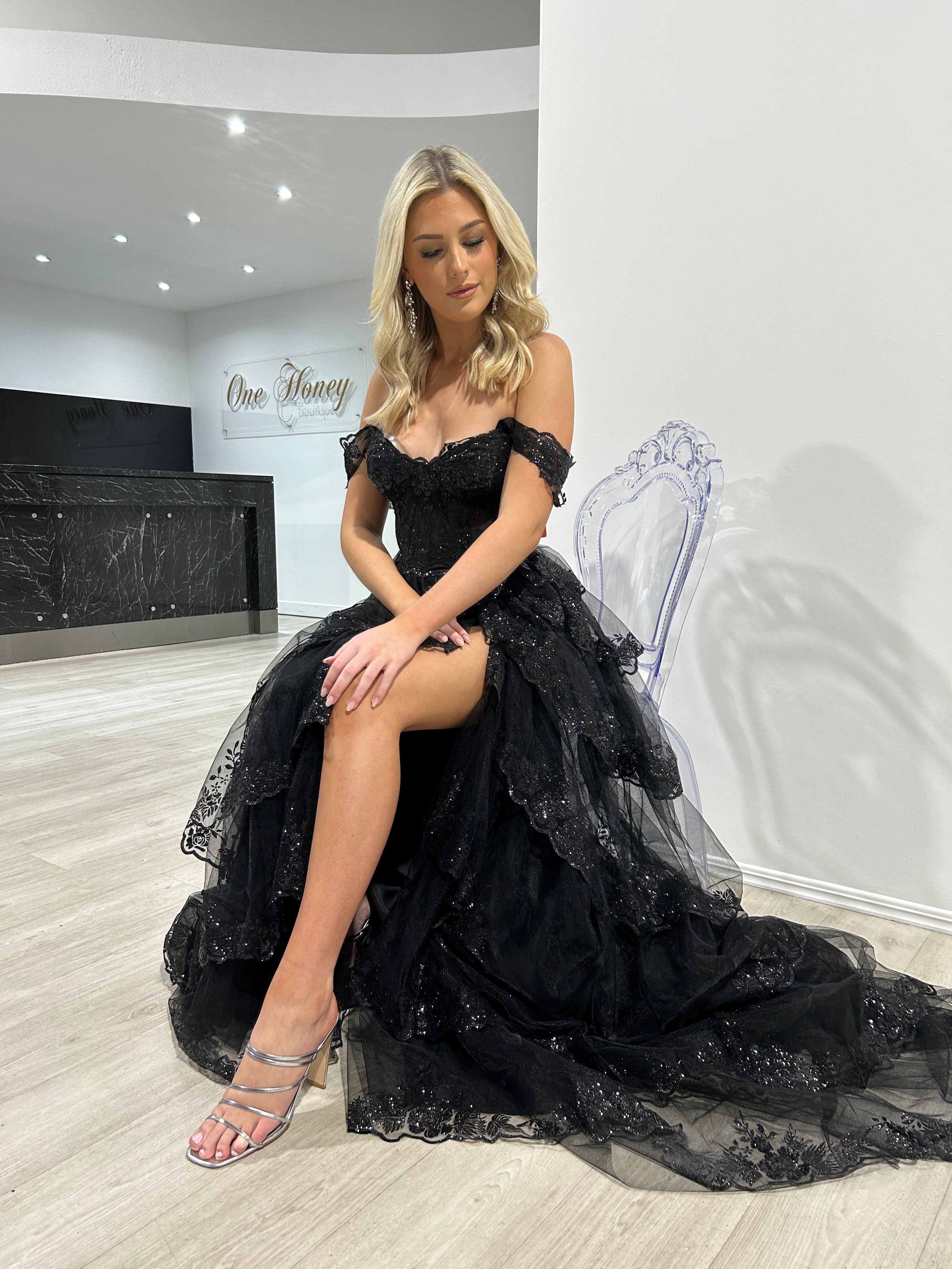 Elegant woman in Honey Couture NATASHA black off-shoulder tulle ball gown, an affordable Australian designer evening dress for prom or formal events.