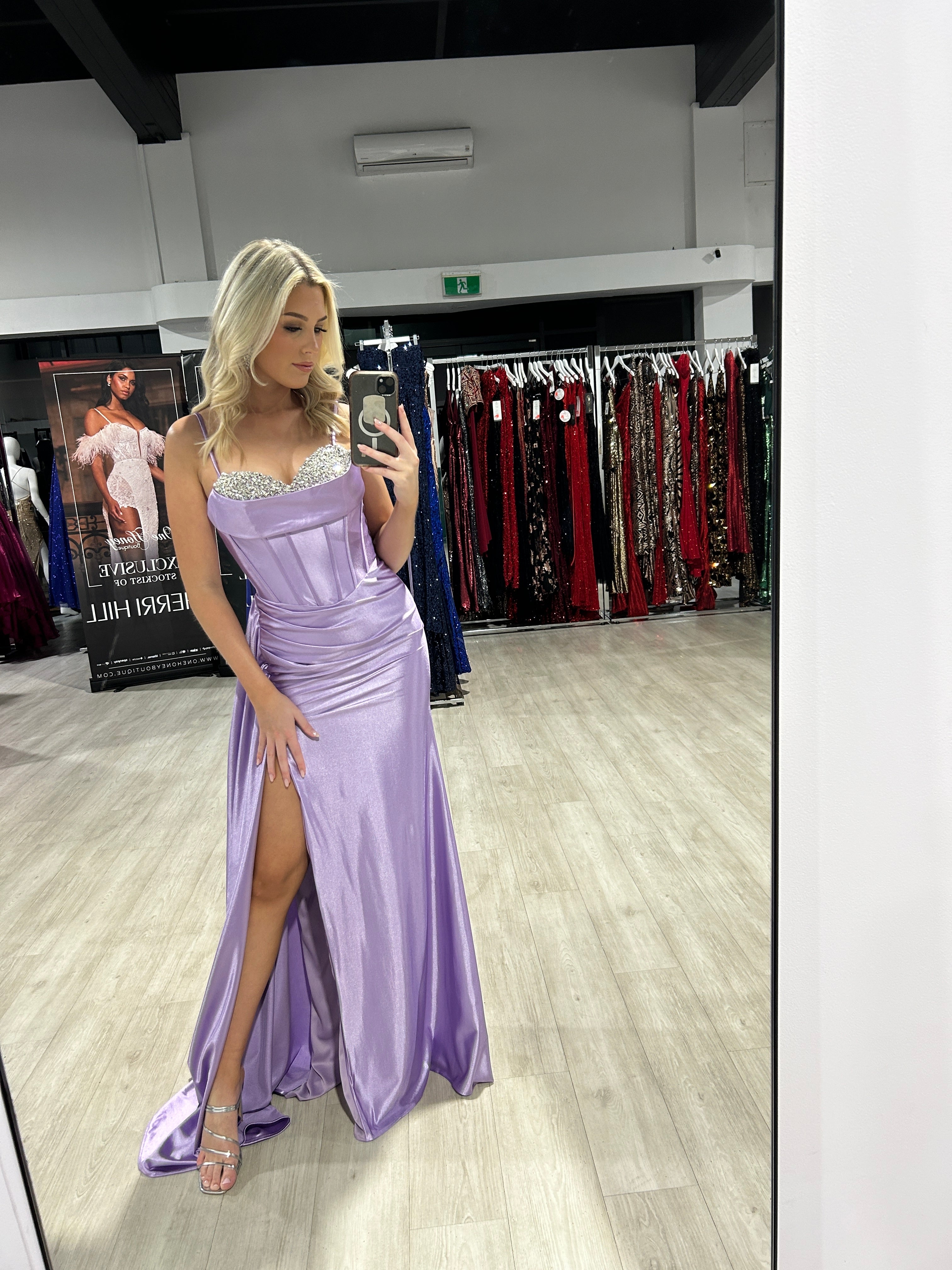 EMILIA Sweetheart beaded corset silky mermaid formal dress with leg split, worn by woman taking selfie in boutique. Brisbane to Gold Coast.