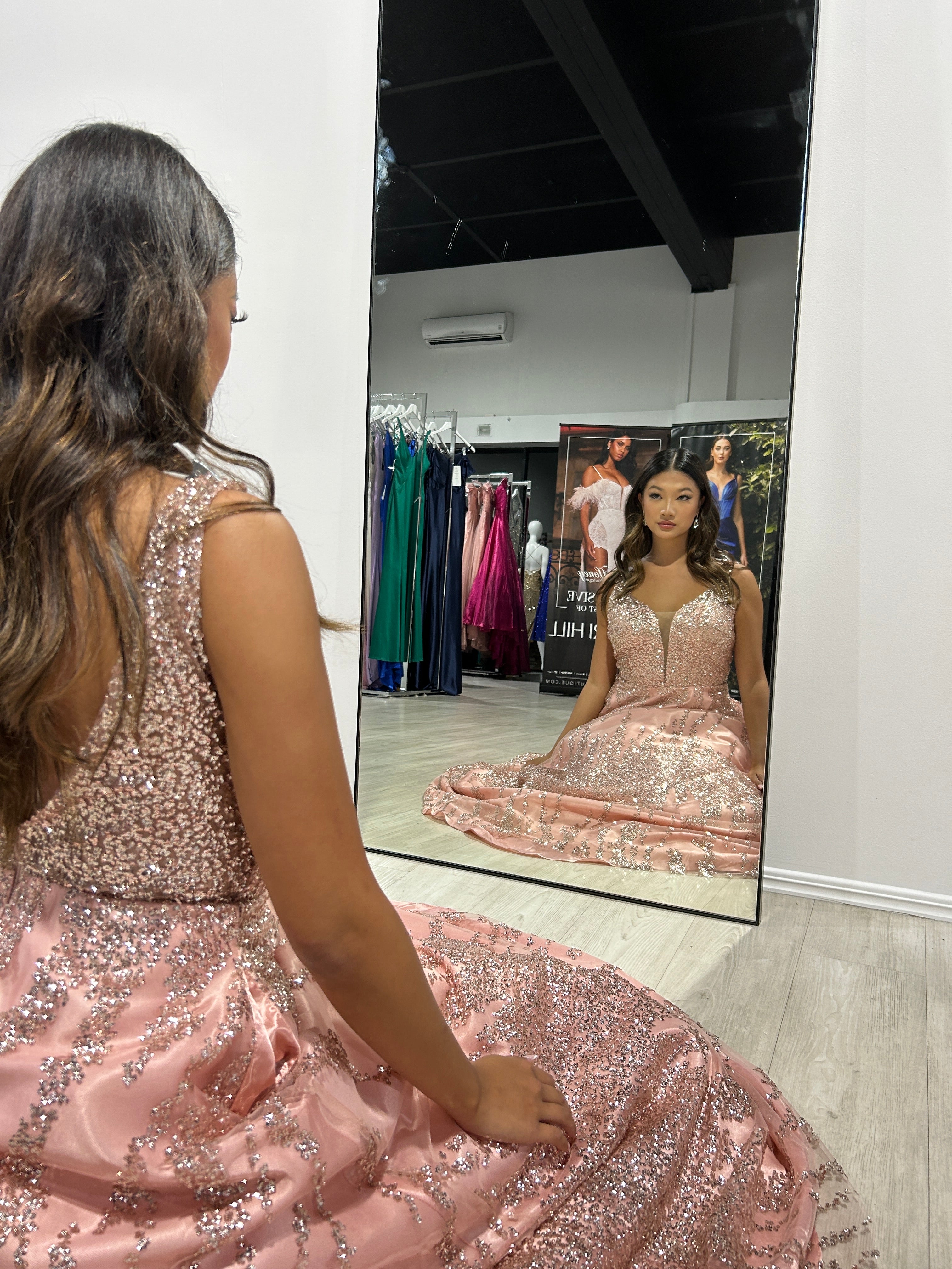 CHARMAINE Rose Gold Glitter Ball Gown with deep-cut V-neckline in a mirror reflection, ideal formal dress for elegant occasions. Brisbane to Gold Coast