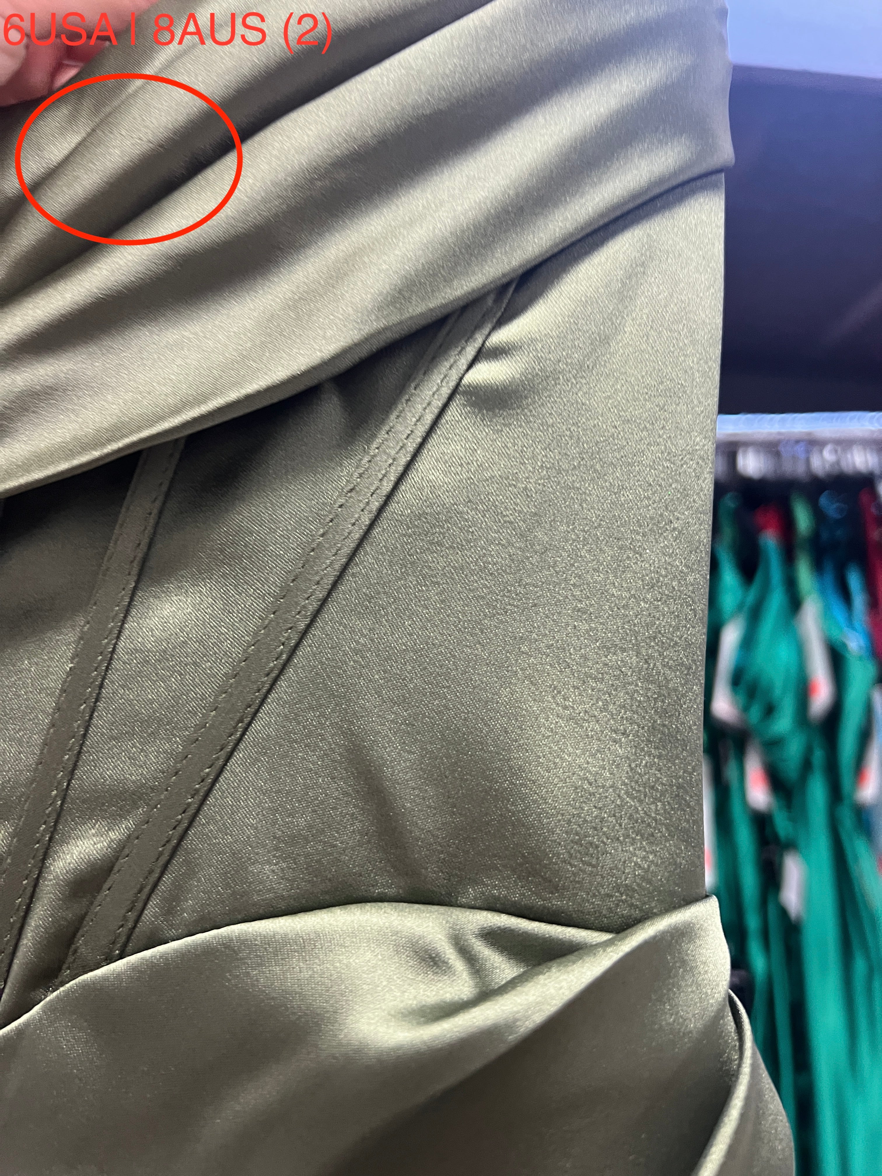 Close-up of Honey Couture ZENDAYA Olive Green Satin Corset Detail, featuring elegant stitching and silky fabric, perfect for formal occasions.