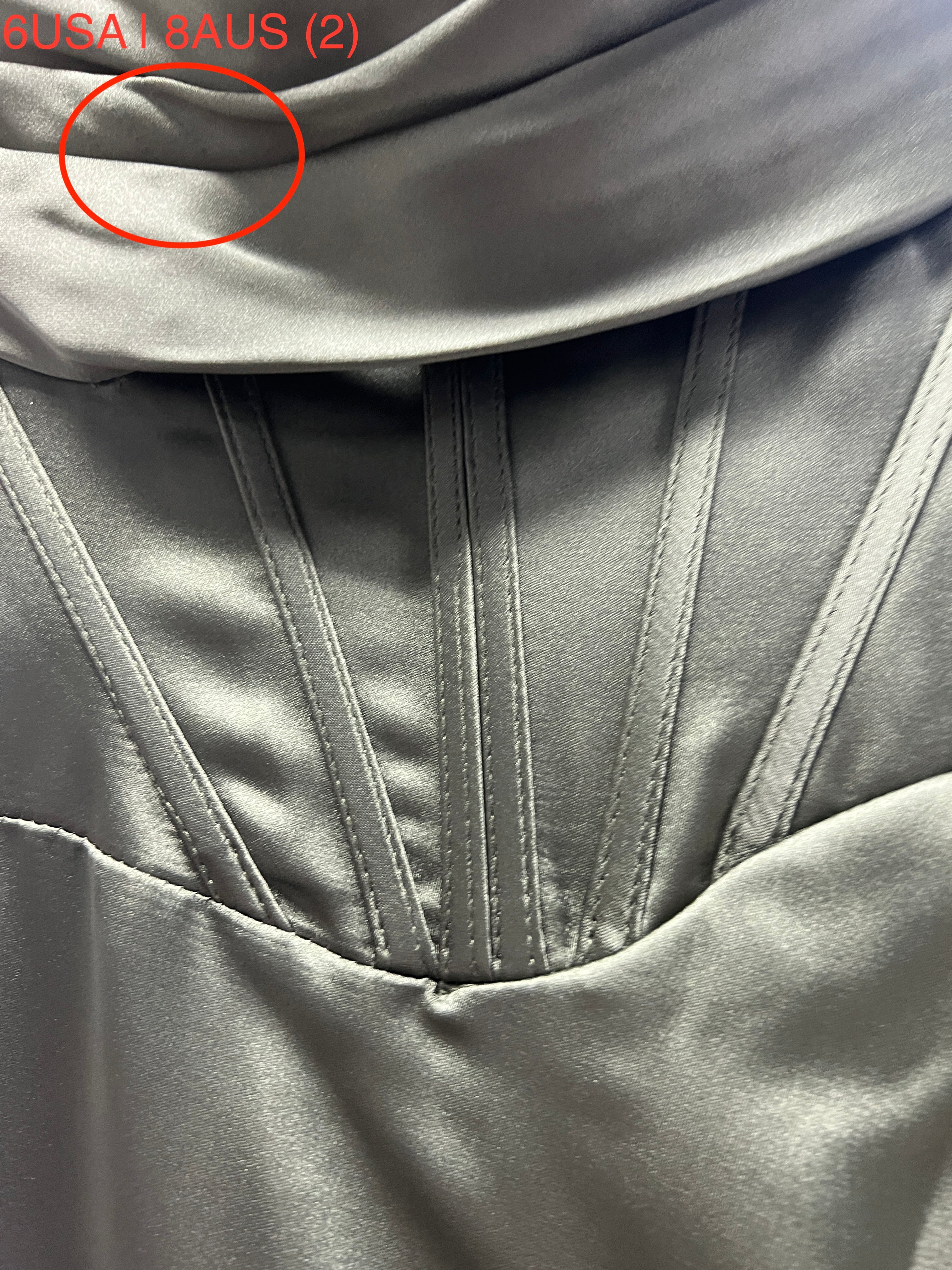 Close-up of Olive Green Satin Fabric on Honey Couture ZENDAYA Dress, featuring elegant stitching and smooth texture.