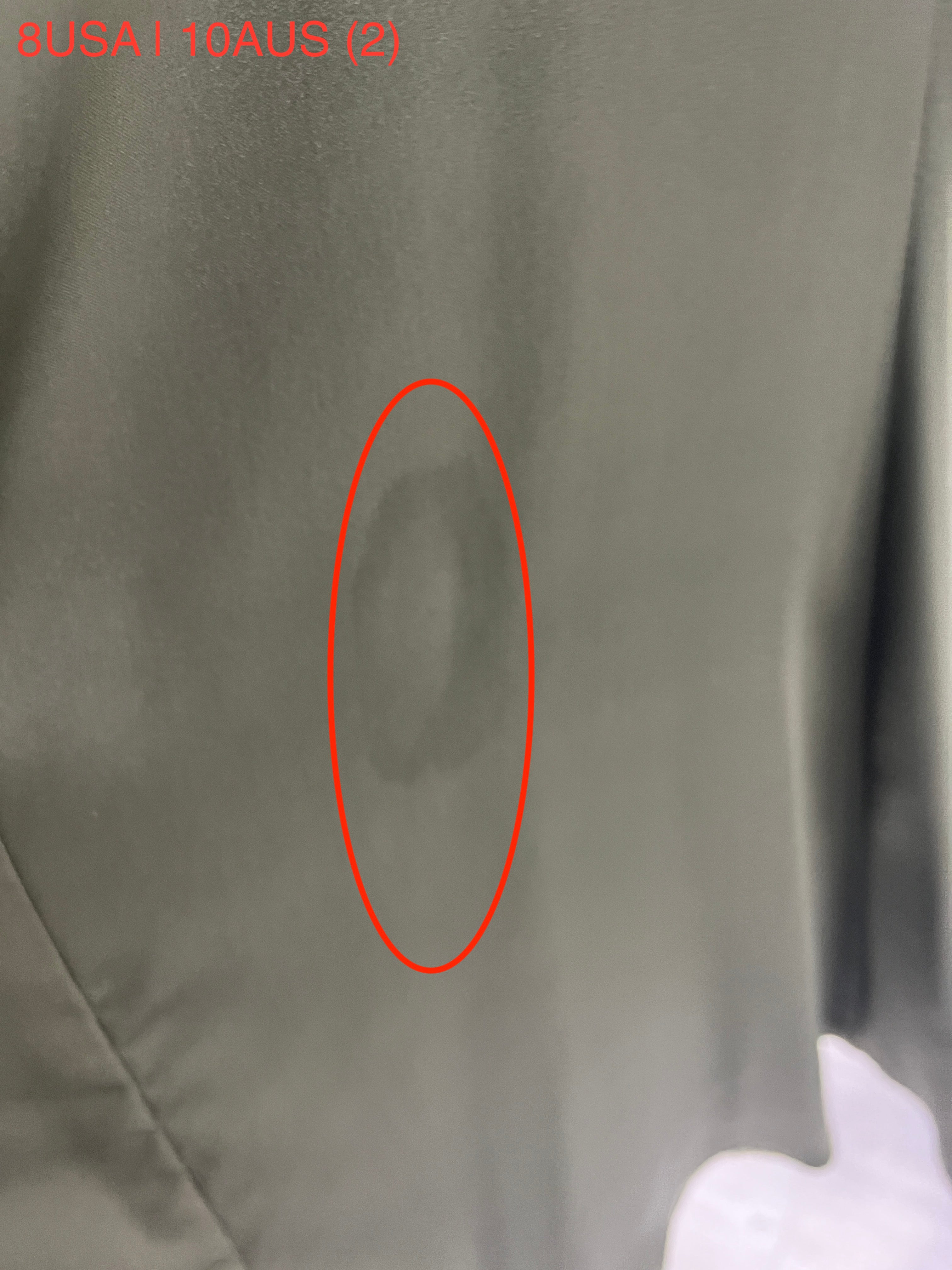 Close-up of fabric detail on Honey Couture ZENDAYA Olive Green Satin Formal Dress, showcasing the dress's texture and style.