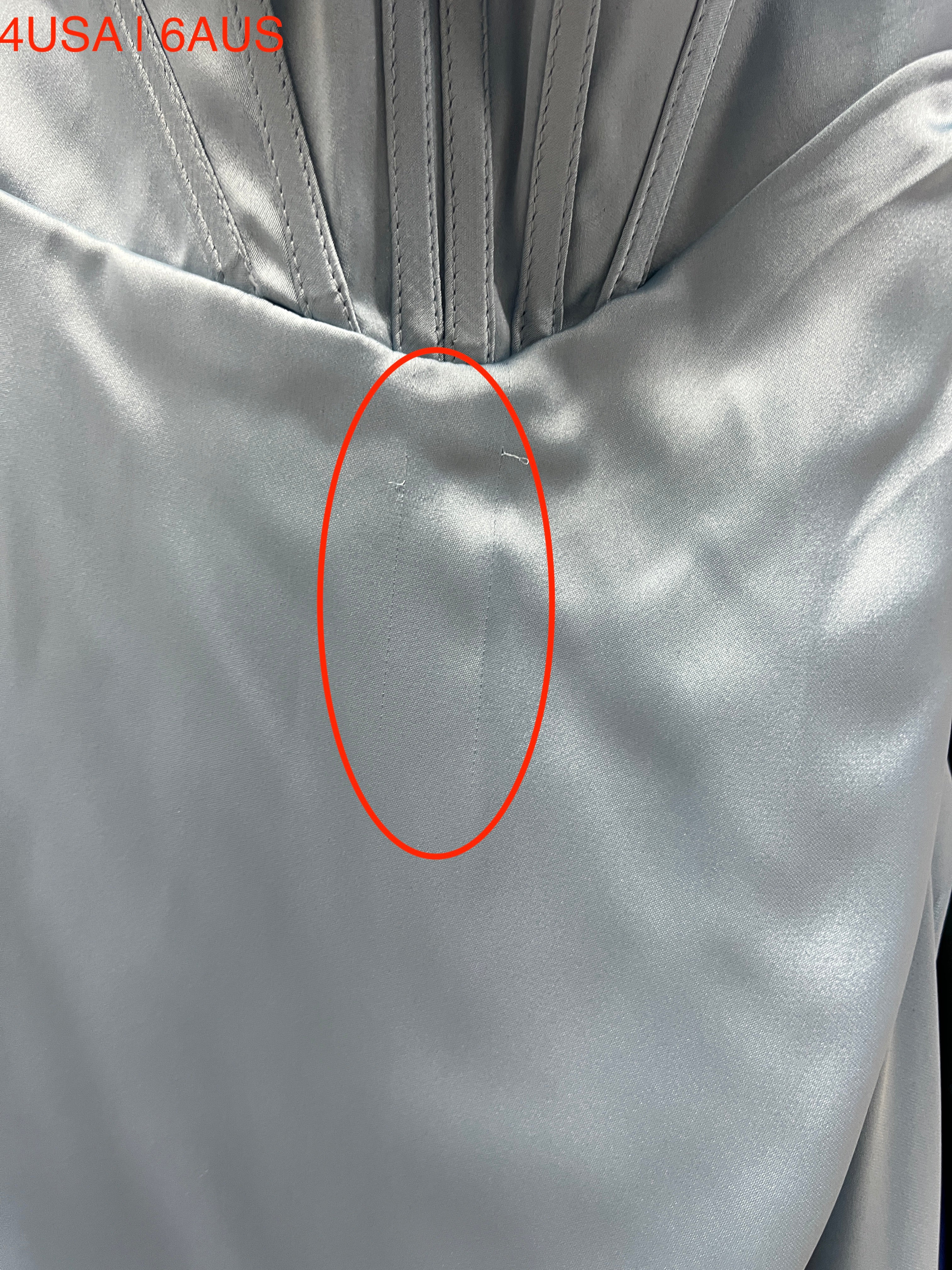 Close-up of light blue satin fabric detail on Honey Couture ZENDAYA formal dress, featuring a hidden corset and leg split design.