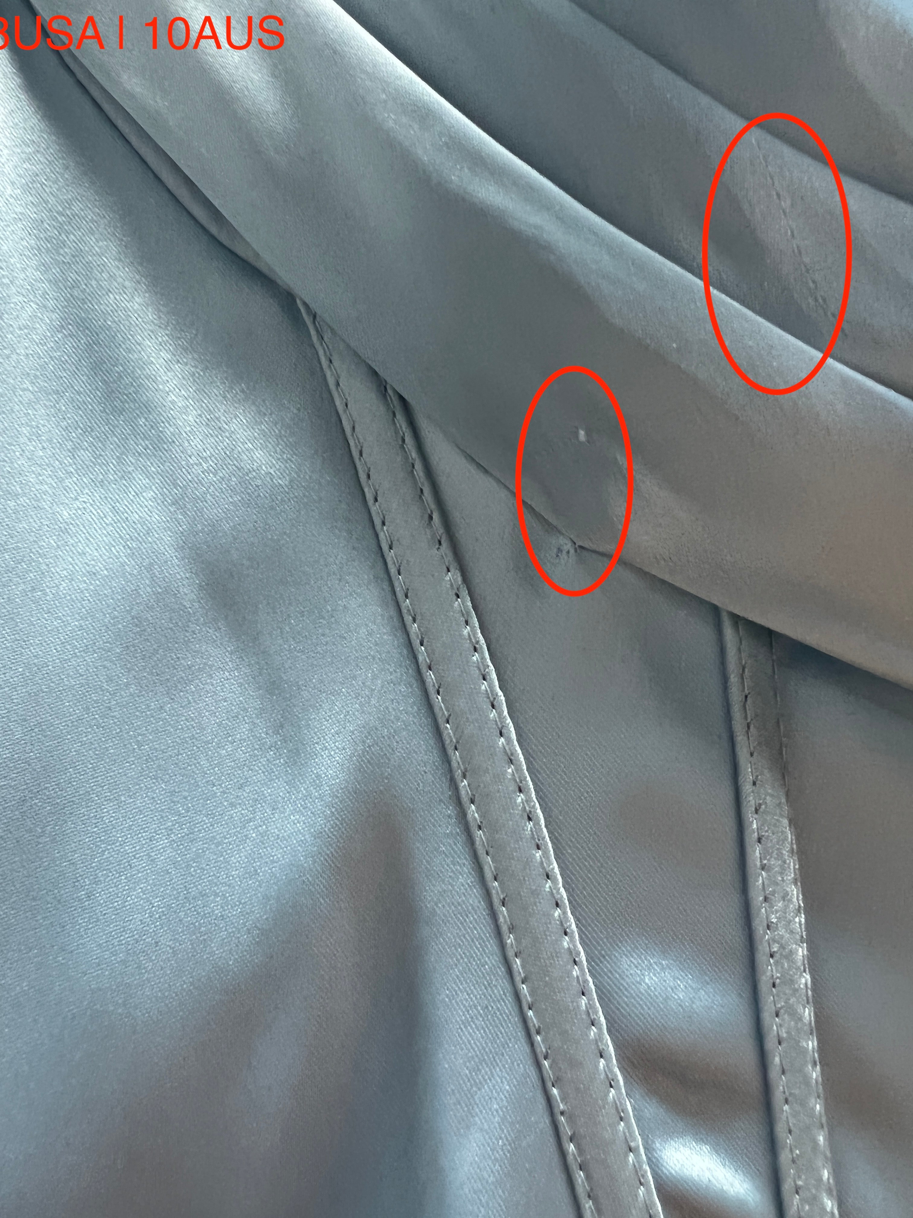 Detailed view of the Honey Couture ZENDAYA Light Blue Satin fabric showing stitching and texture.