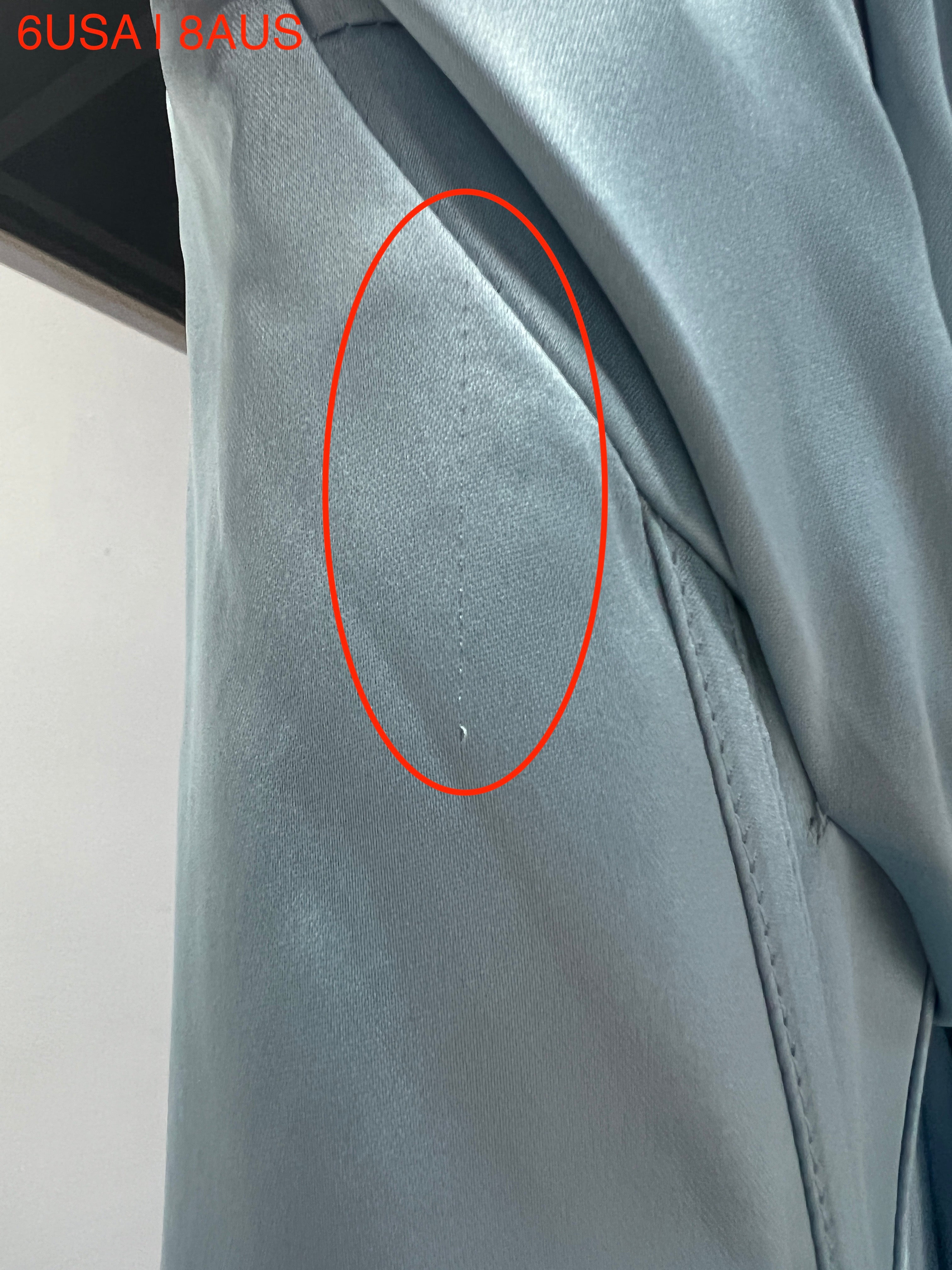 Close-up of the Honey Couture ZENDAYA Light Blue Satin Dress fabric defect, showcasing the texture and color. Australian Designer Prom Gown.