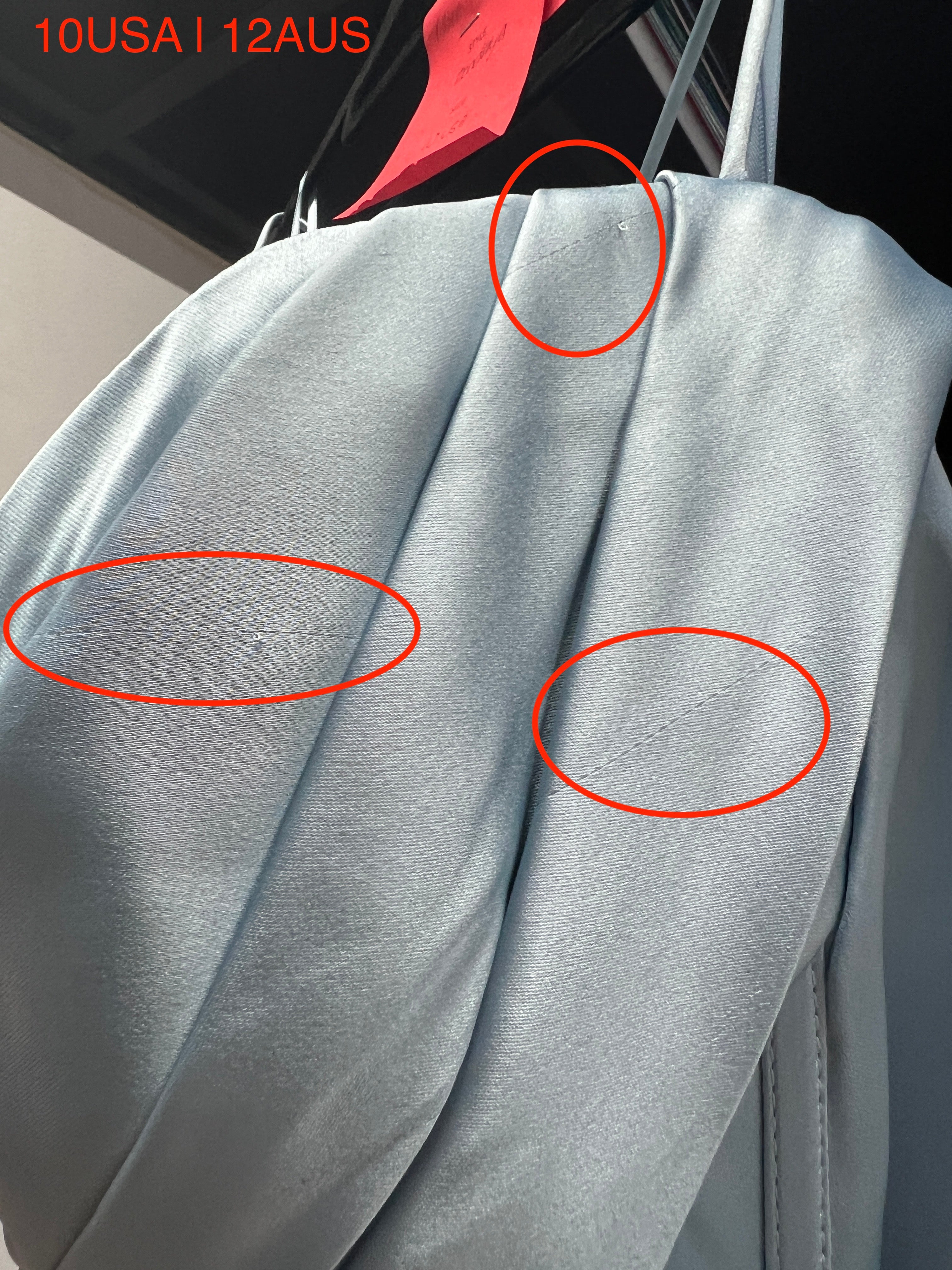 Close-up of light blue fabric details with visible imperfections, size 10 USA 12 AUS.