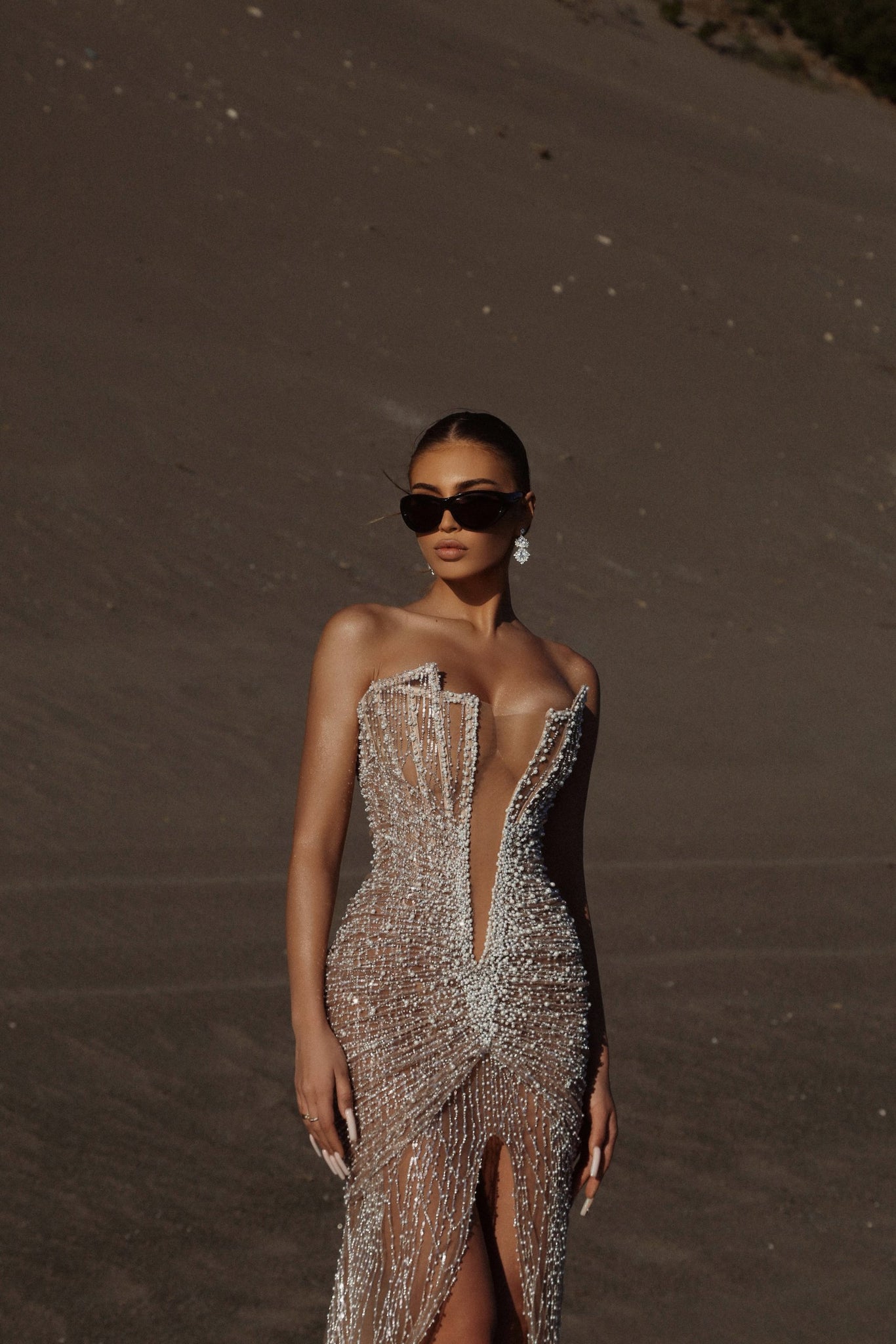 MINNA Fashion ZOE strapless beaded mermaid evening gown with pearl detail, worn by model on sandy landscape. Brisbane to Gold Coast.