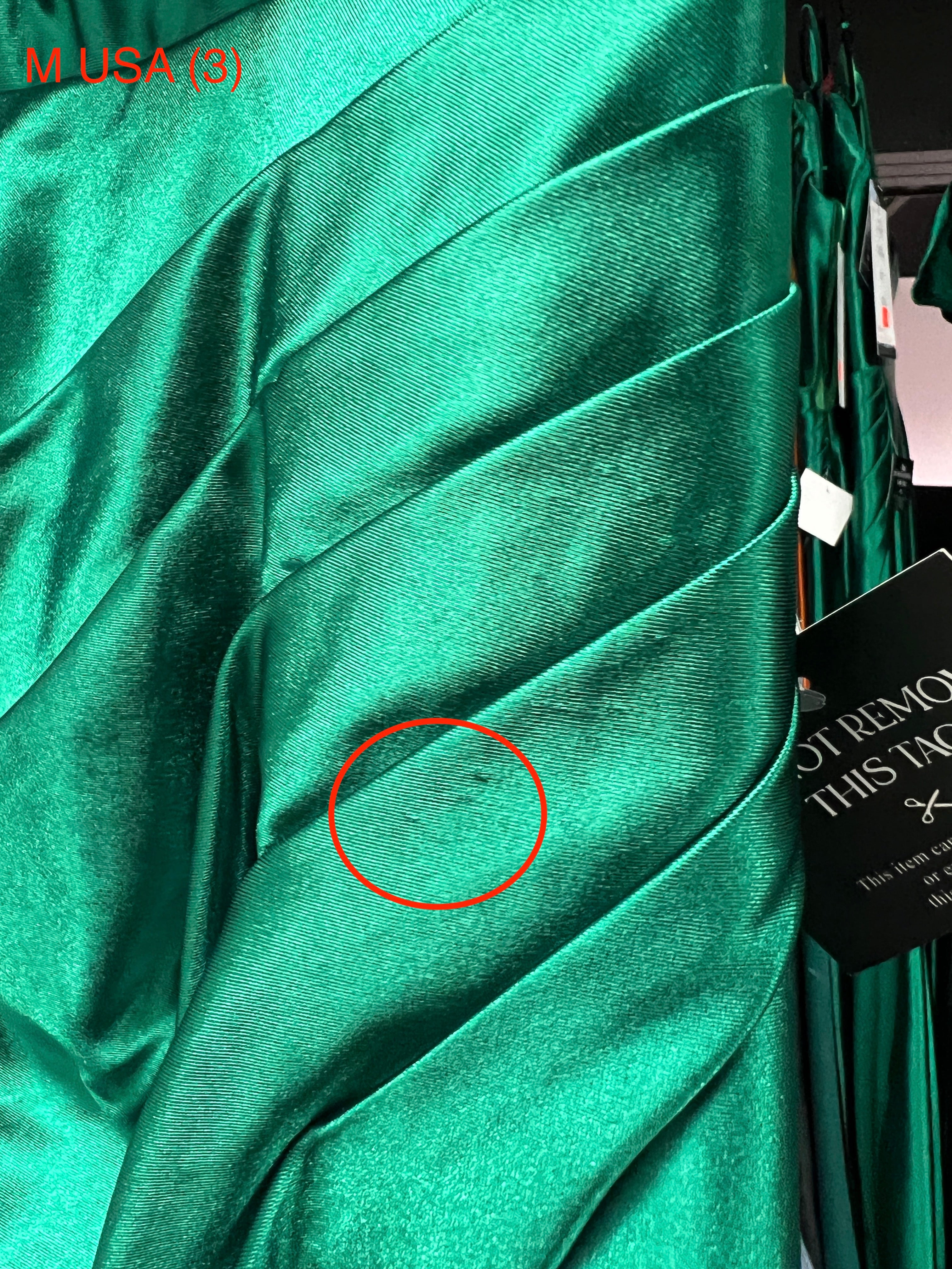 Close-up of Honey Couture SHARYN Emerald Green Strapless Mermaid Dress fabric detailing, showcasing luxurious silky texture and design.