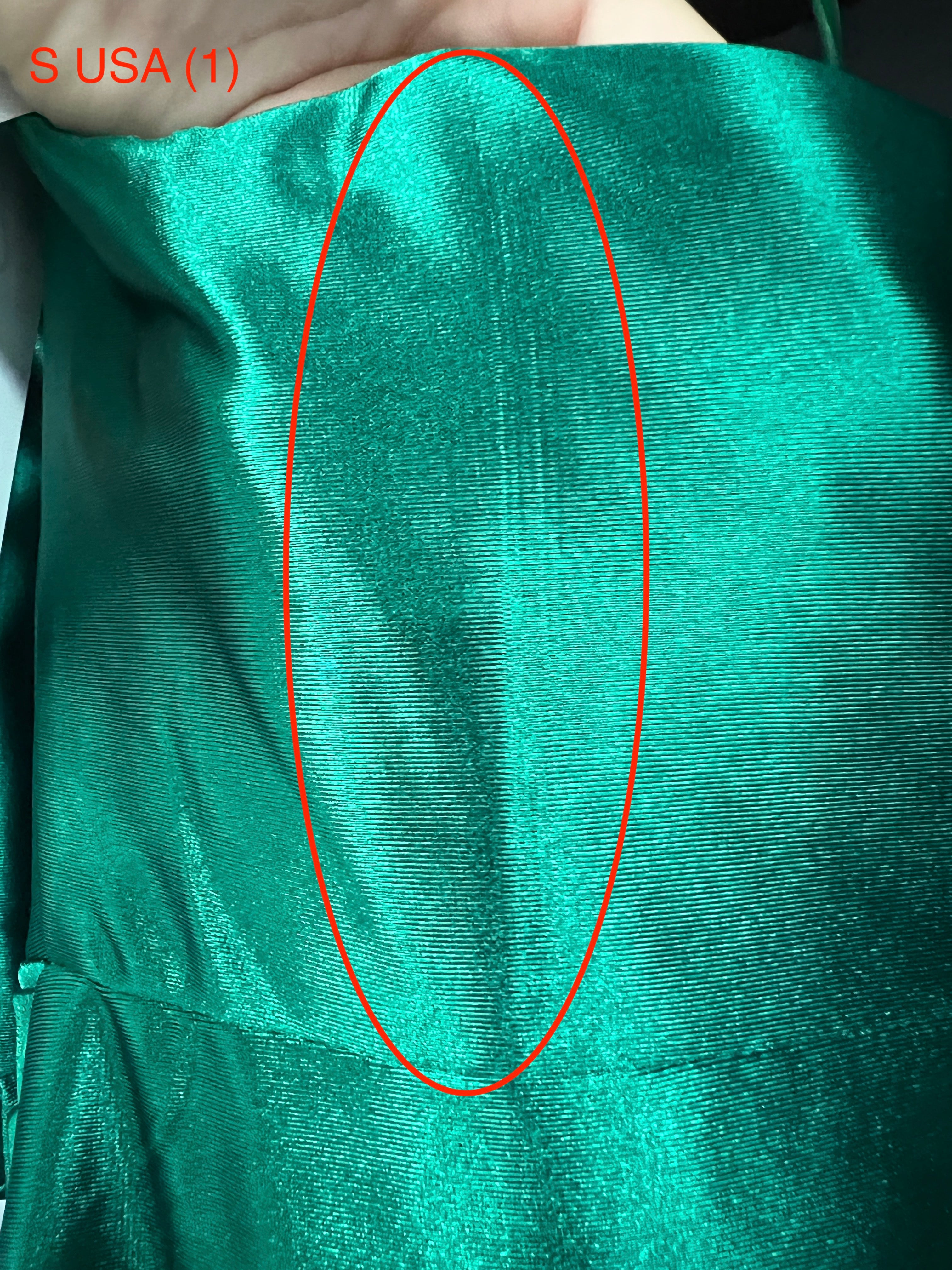 Close-up of Honey Couture SHARYN Emerald Green Prom Dress fabric, showing silky texture and vibrant color.
