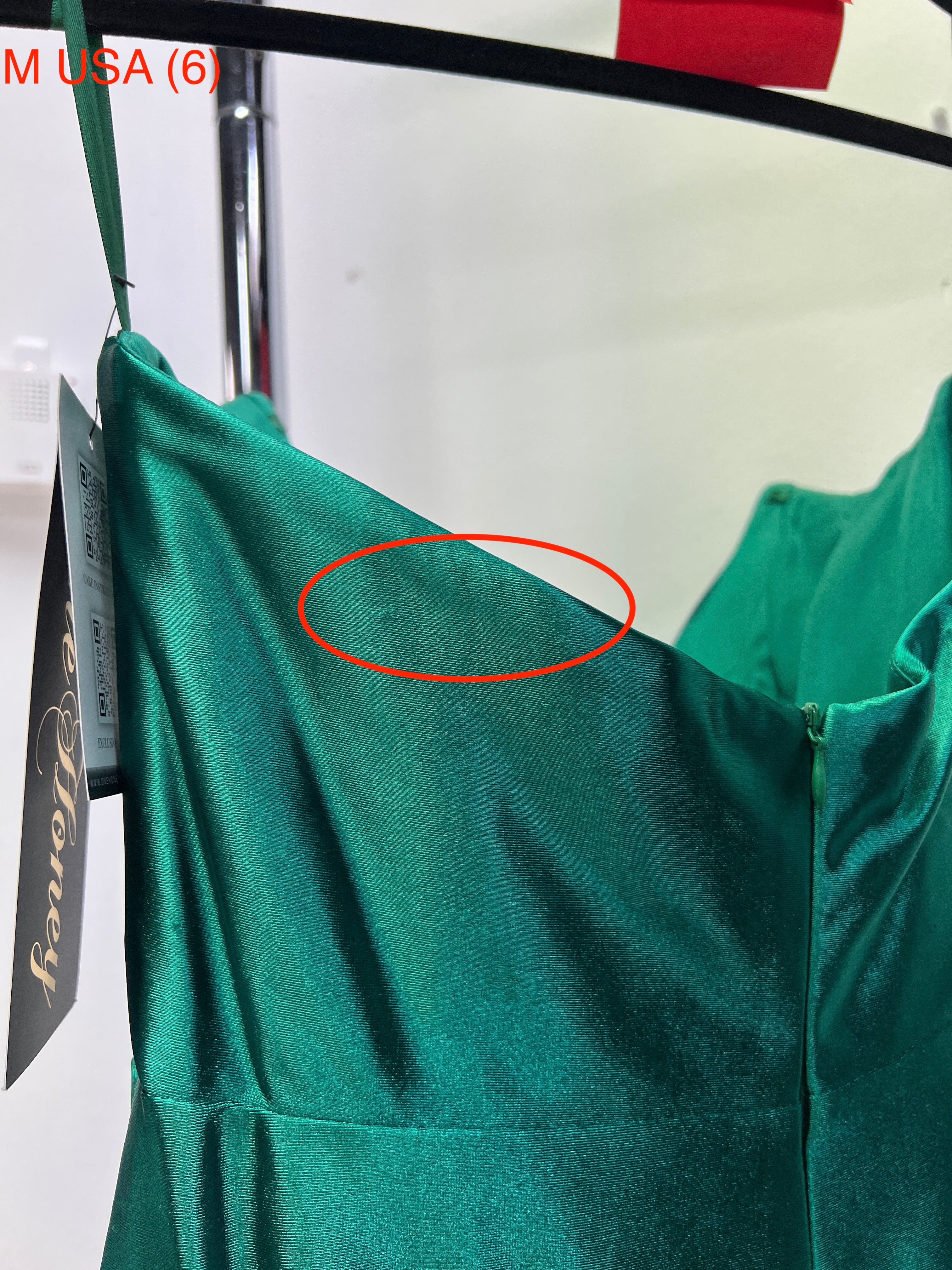 Emerald green dress on hanger showing silky fabric and corset bustier detail, Honey Couture SHARYN, evening gown, affordable Australian designer.