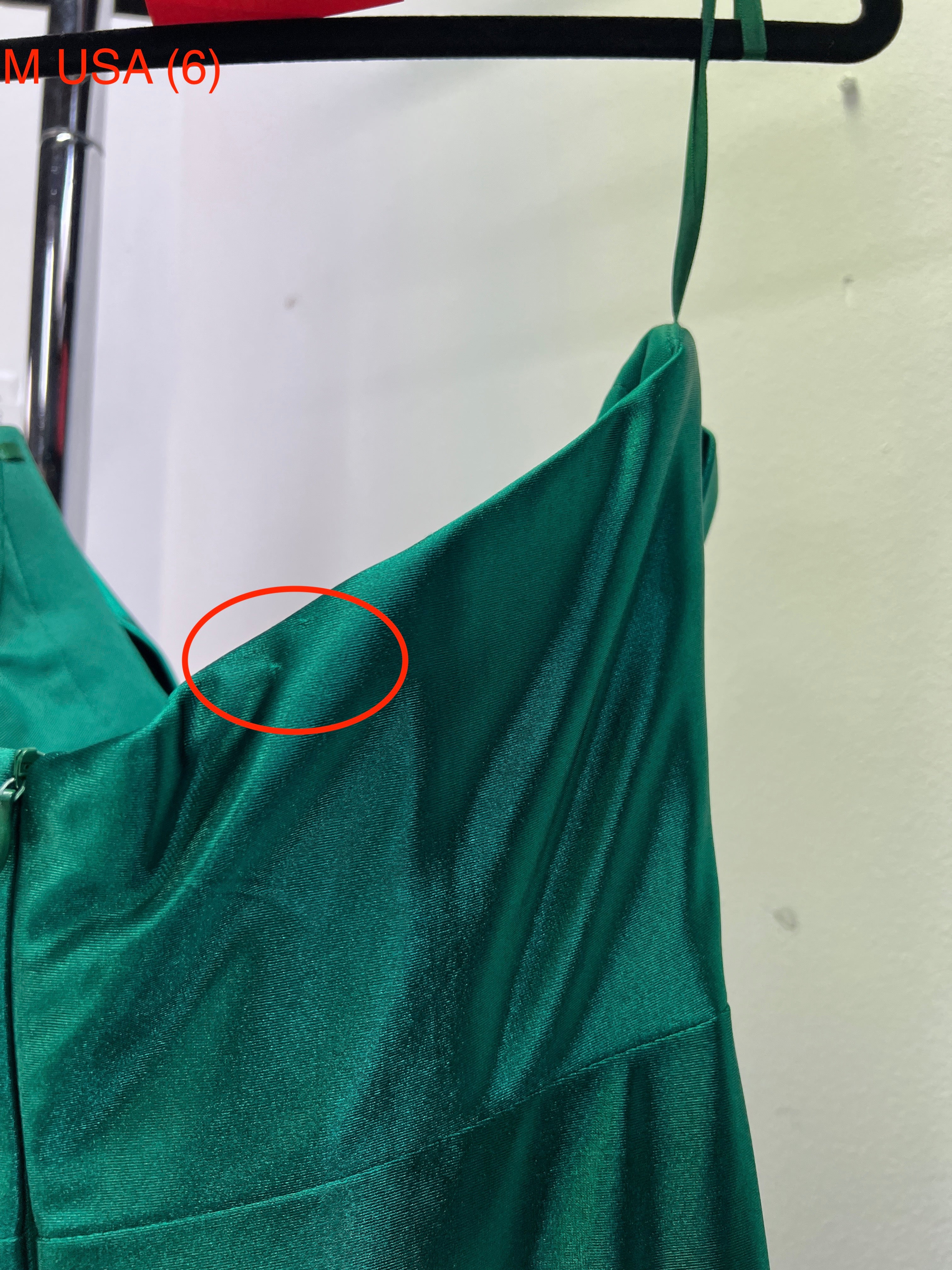 Close-up of Honey Couture SHARYN emerald green silky corset strapless evening gown from Australian Designer, showcasing zipper and strap detail.