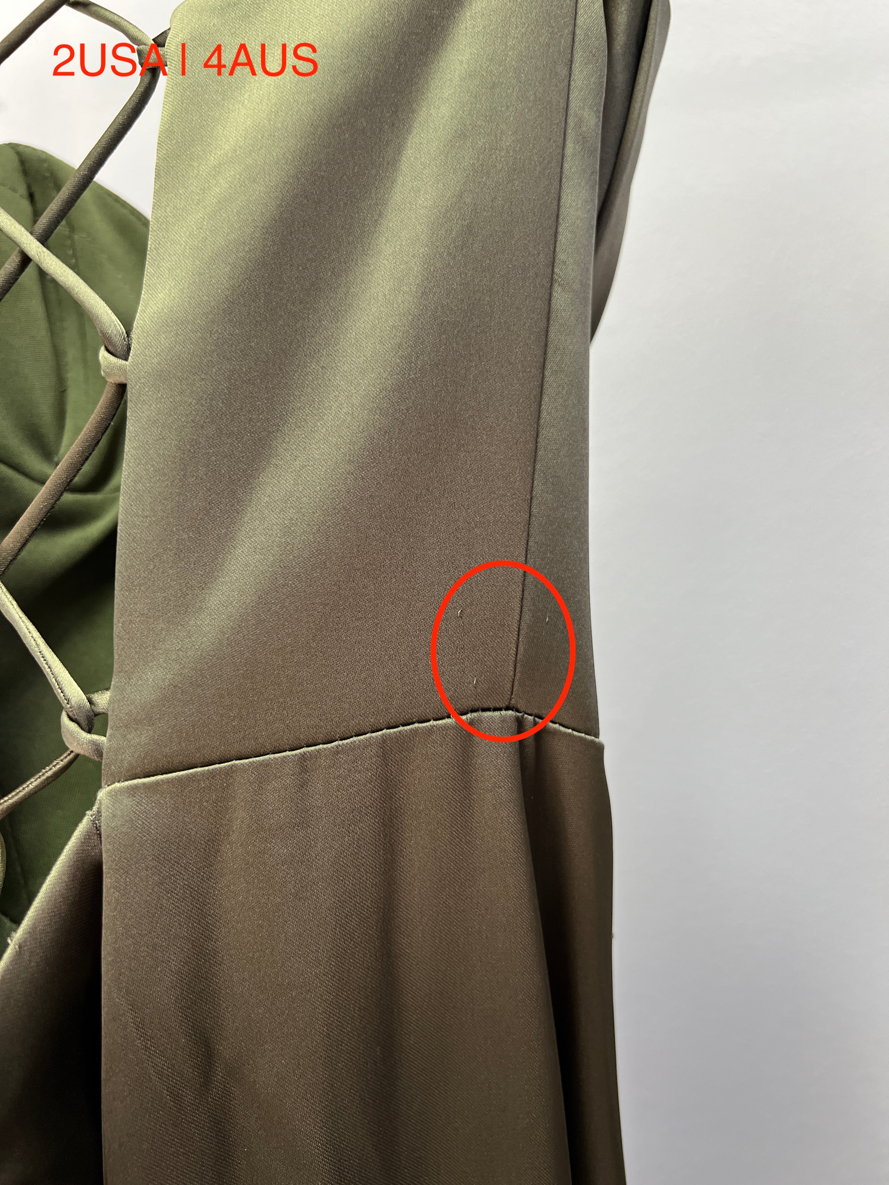 Close-up of the Honey Couture ZENDAYA Satin Corset with lace-up back, showcasing detailed stitching and fabric in olive green.