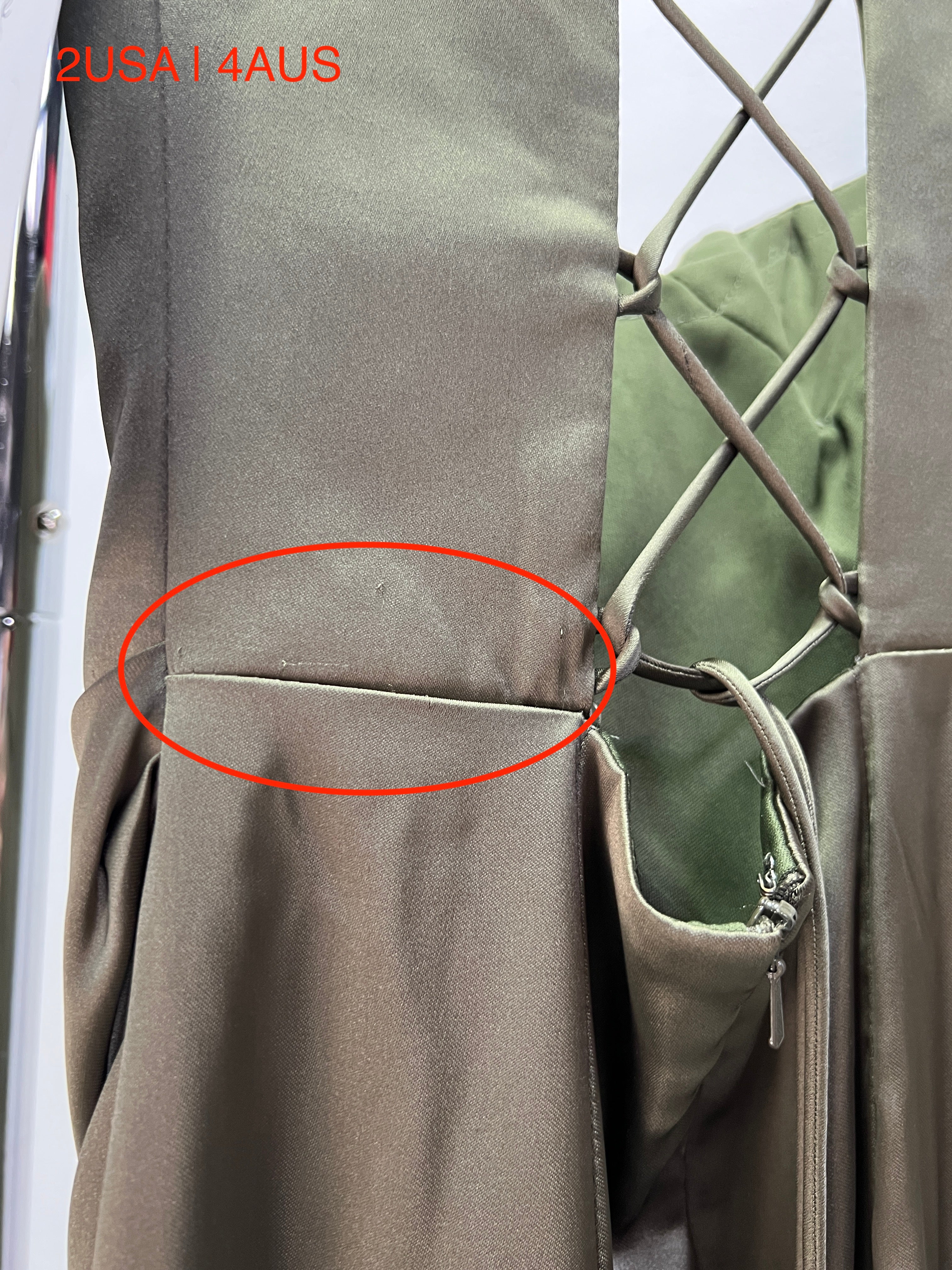 Close-up of Honey Couture ZENDAYA Olive Green Satin Corset Bustier Dress with lace-up back, showing fabric texture and seam details.