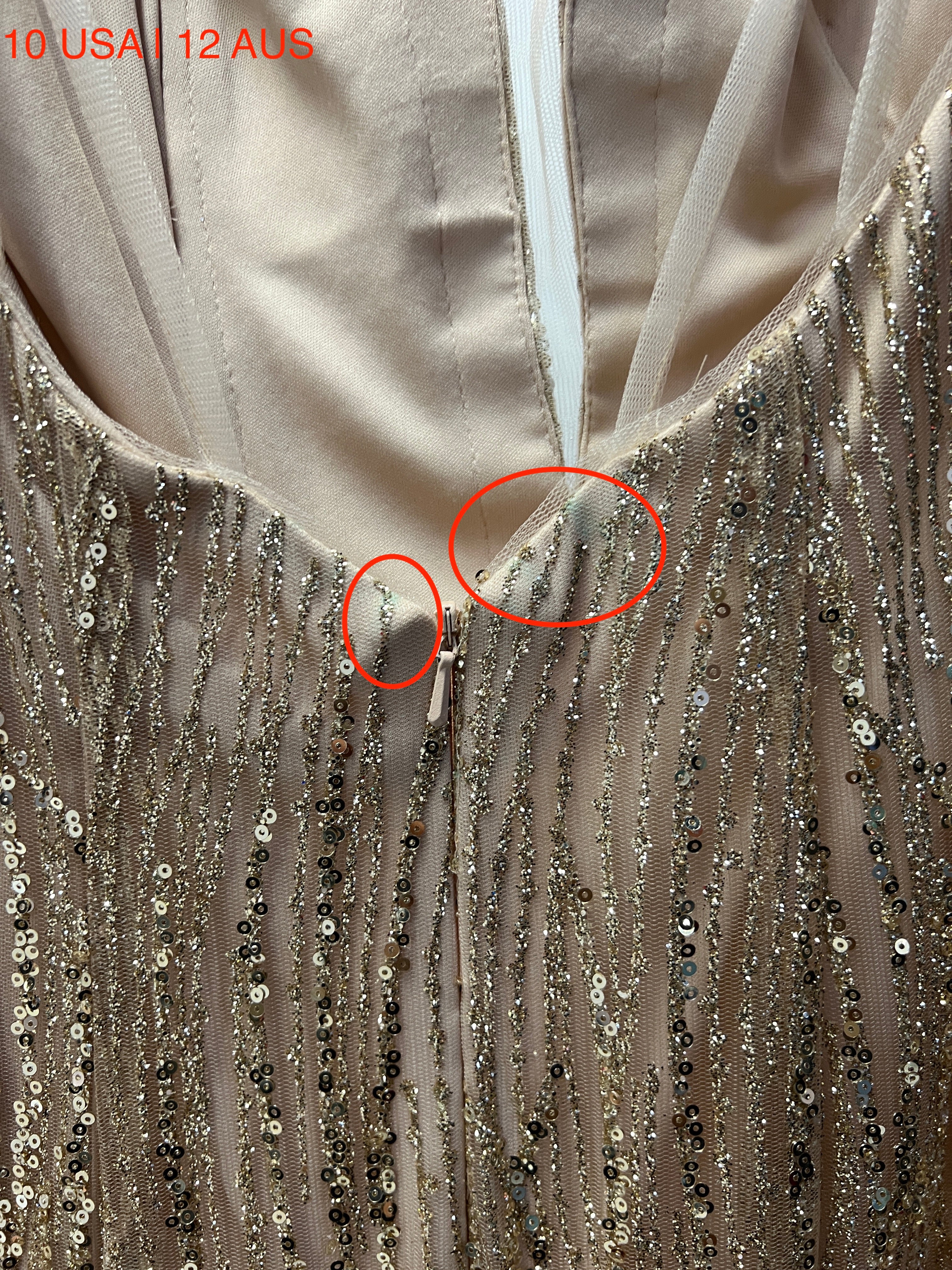 Close-up of Honey Couture ISABELLA gold sequin mermaid gown showing detail of sequins and fabric with size 10 USA, 12 AUS labeled.