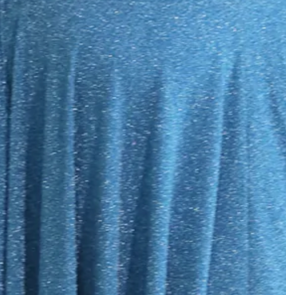 Blue glitter fabric with a soft, flowing texture, capturing light beautifully, ideal for festive or elegant occasion wear.