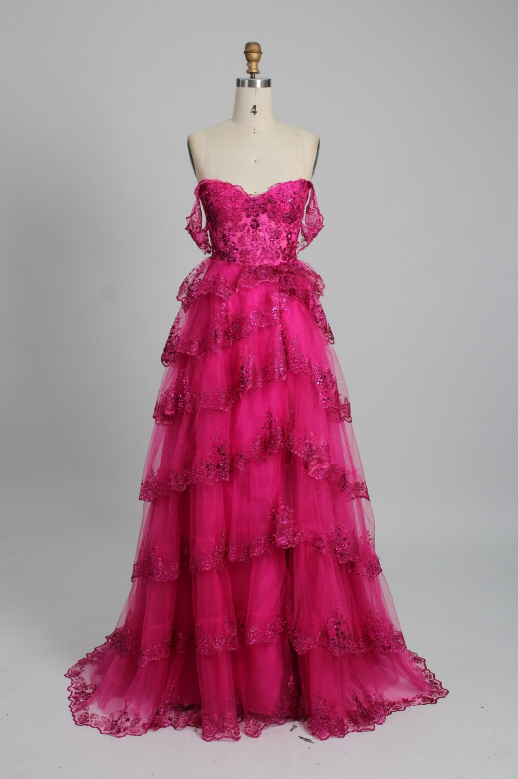 Honey Couture NATASHA Off Shoulder Layered Tulle Ball Gown in pink on a mannequin. Australian Designer Prom Dress for formal occasions.