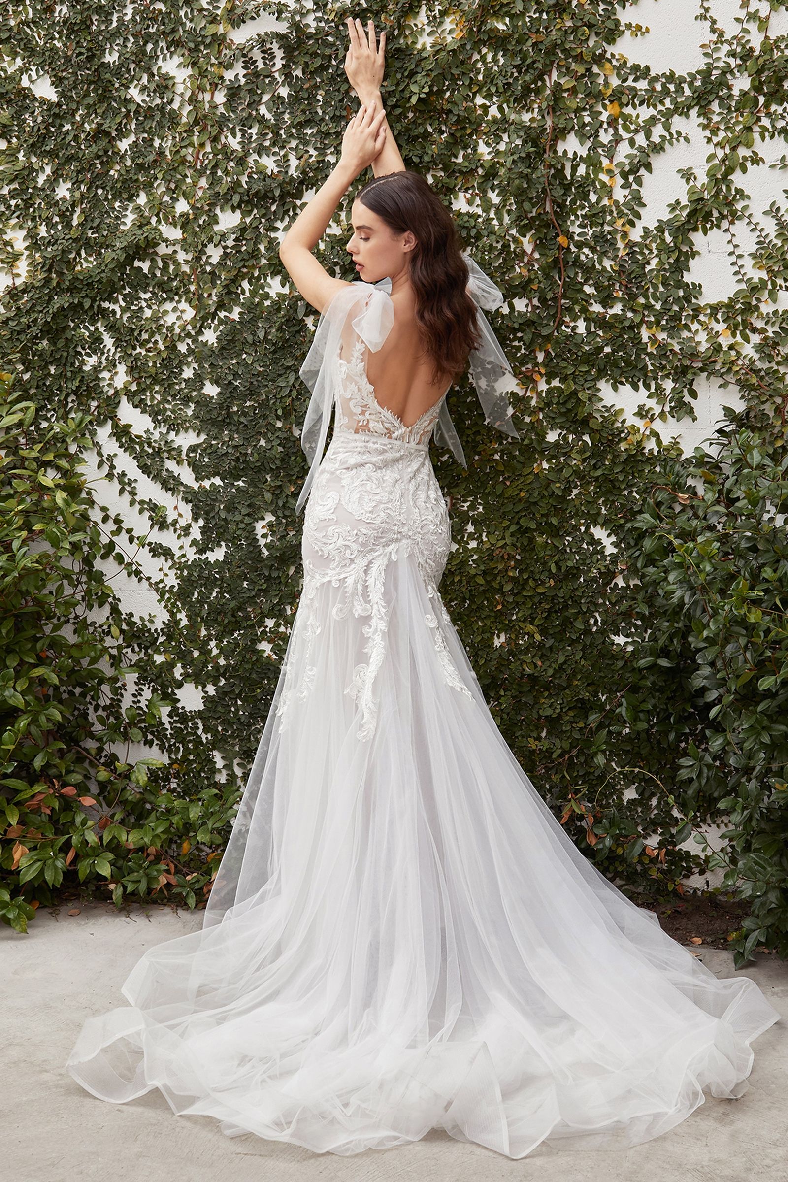 Rear view of the Divinity Bridal BEATRICE lace mermaid wedding dress, featuring a flowing train and elegant details. Ideal affordable bridal choice.