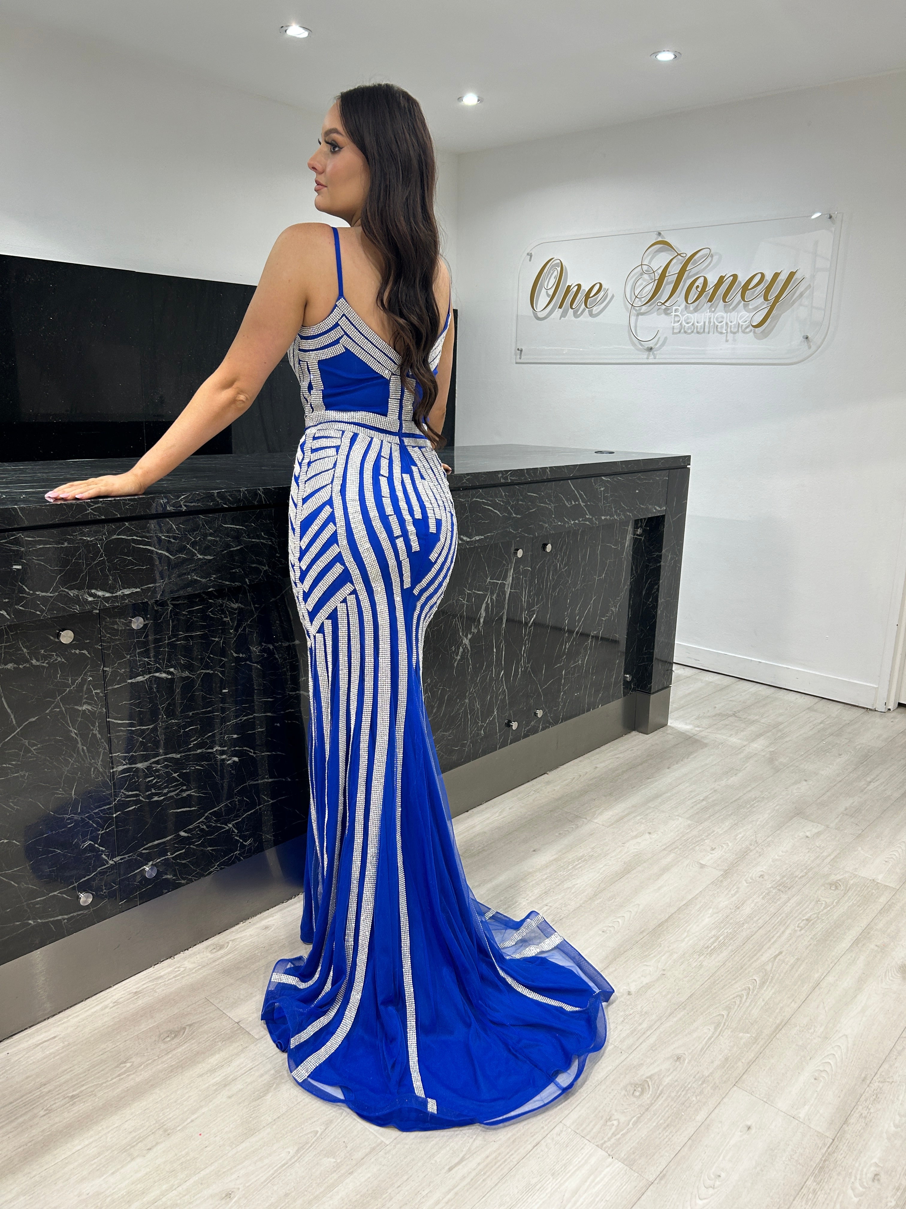 Woman in blue and white mermaid gown with geometric patterns