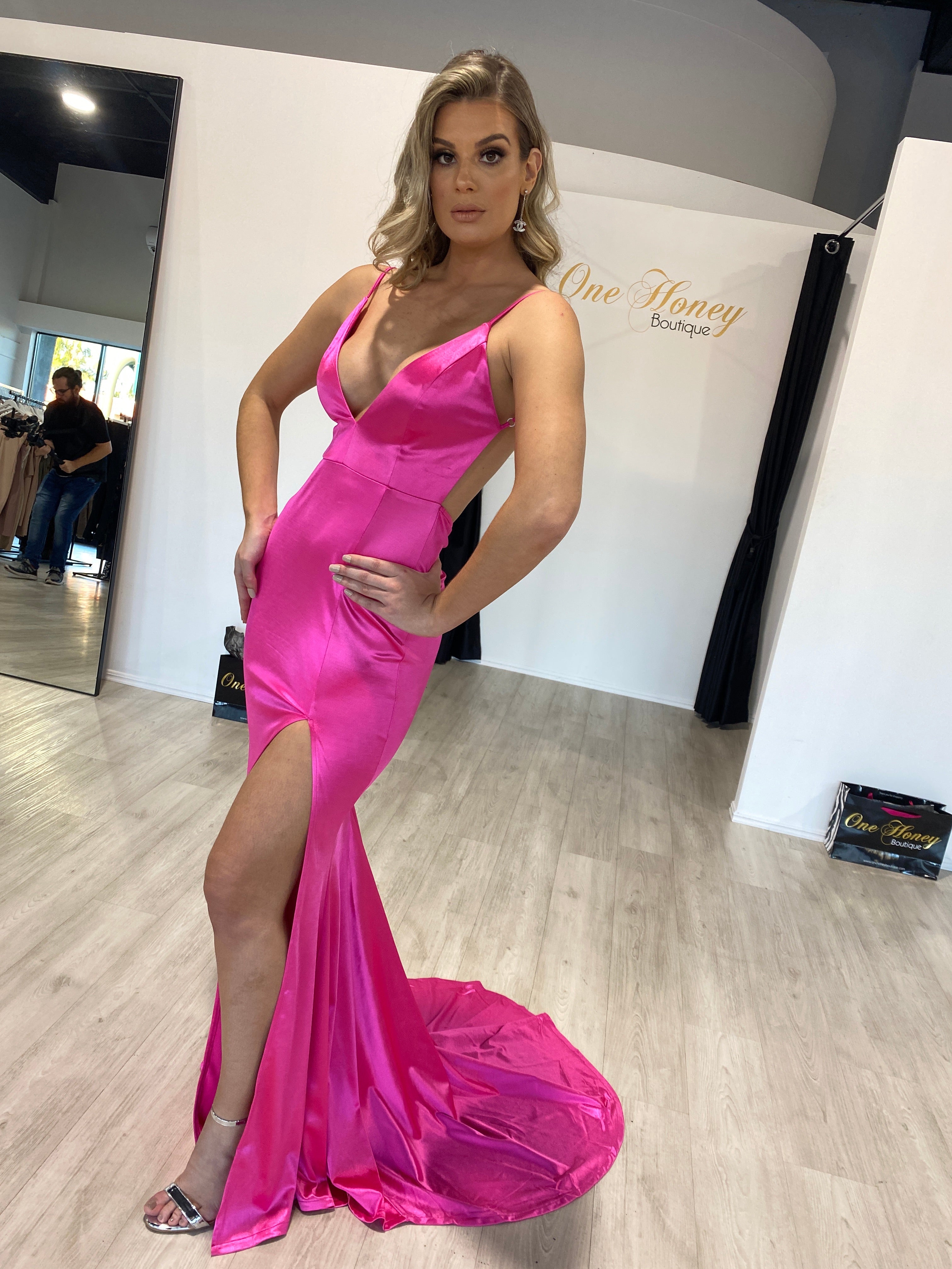 Woman in pink Honey Couture MILEE Low Back Mermaid Evening Gown with leg split, showcasing Australian designer style for prom.