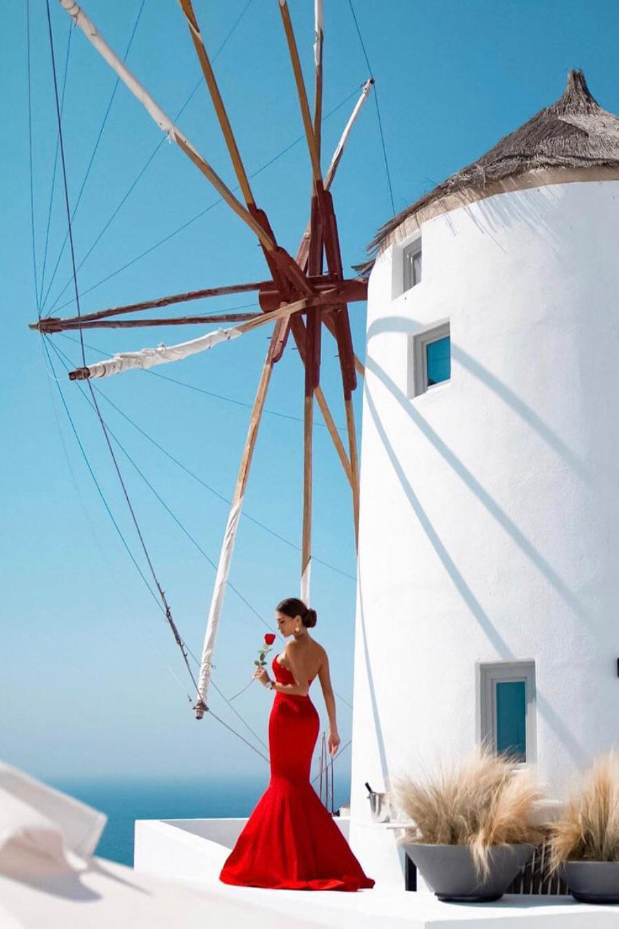 TINA HOLLY COUTURE BA651 red satin strapless mermaid formal dress, woman holding red rose, windmill backdrop, Brisbane to Gold Coast