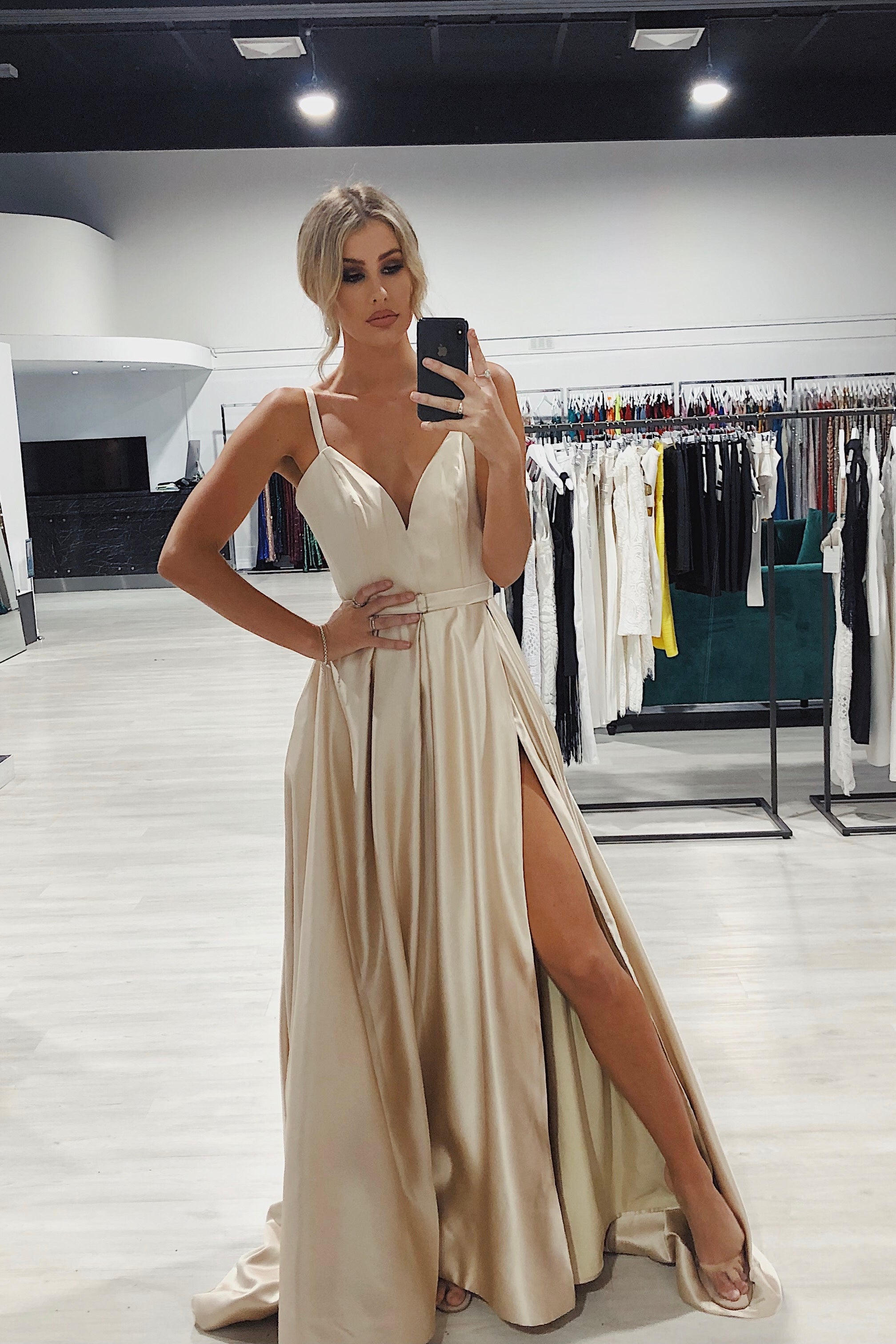 Evie wearing Honey Couture RACHRAY Bustier Pockets Formal Gown, a luxurious Australian Designer prom dress with thin straps, in a boutique. Affordable evening gown.