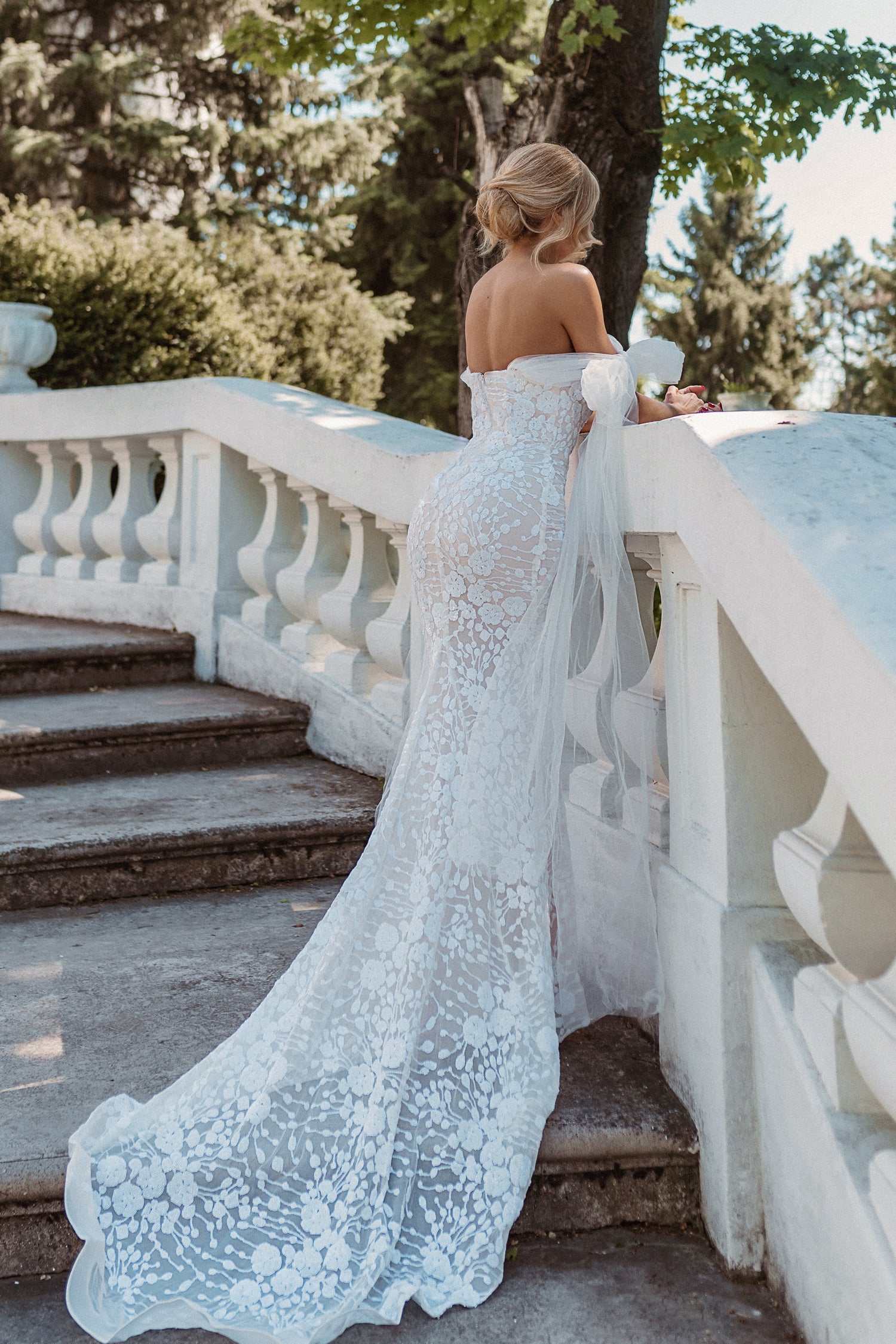 TINA HOLLY COUTURE BB010 off-shoulder wedding dress with embroidered bodice and tulle bow on stairs, Brisbane to Gold Coast