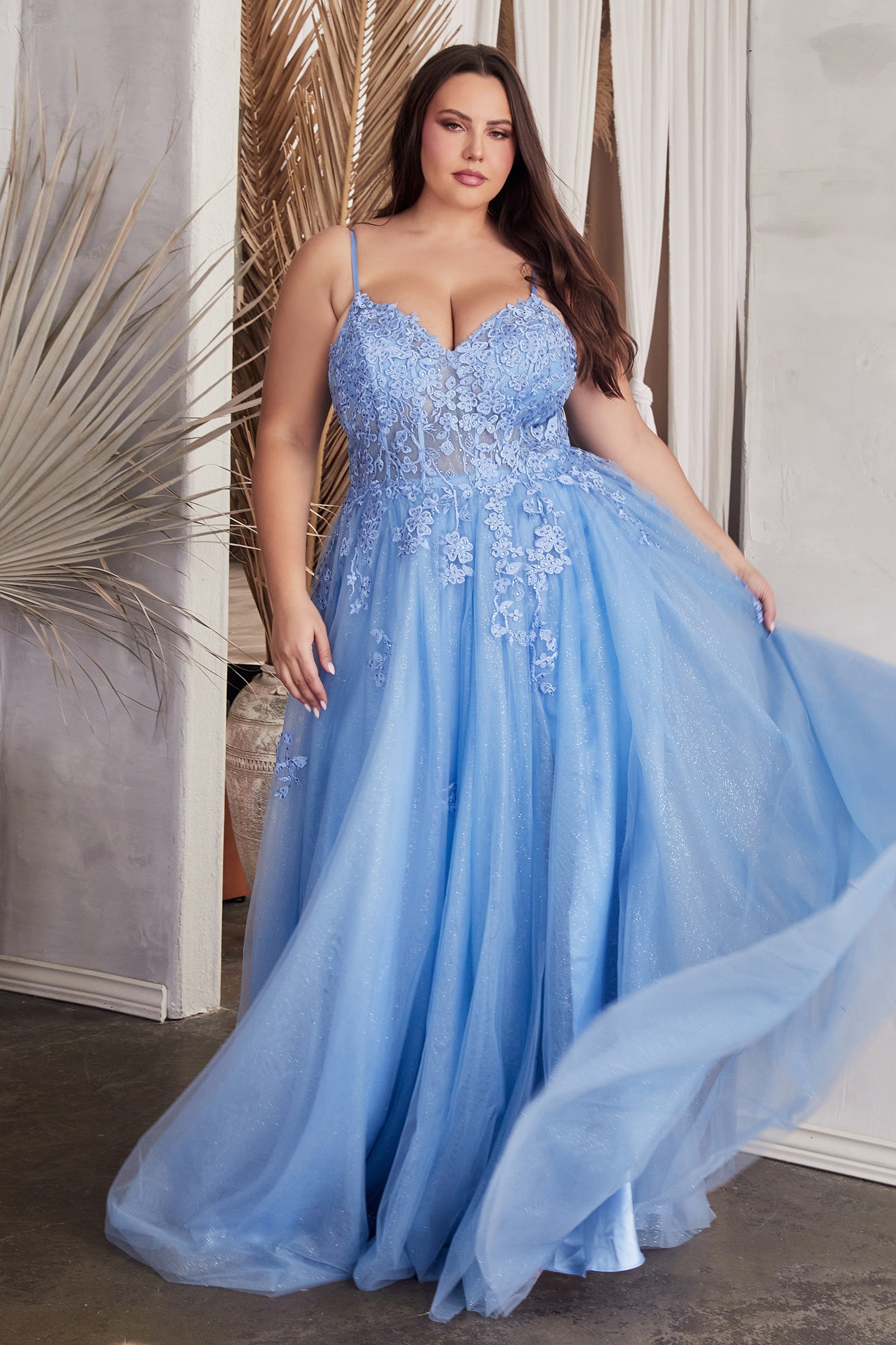 Plus size model wearing blue FEMME Curves BRYDIE lace applique tulle prom dress showcasing a flattering v-neckline and elegant flow.