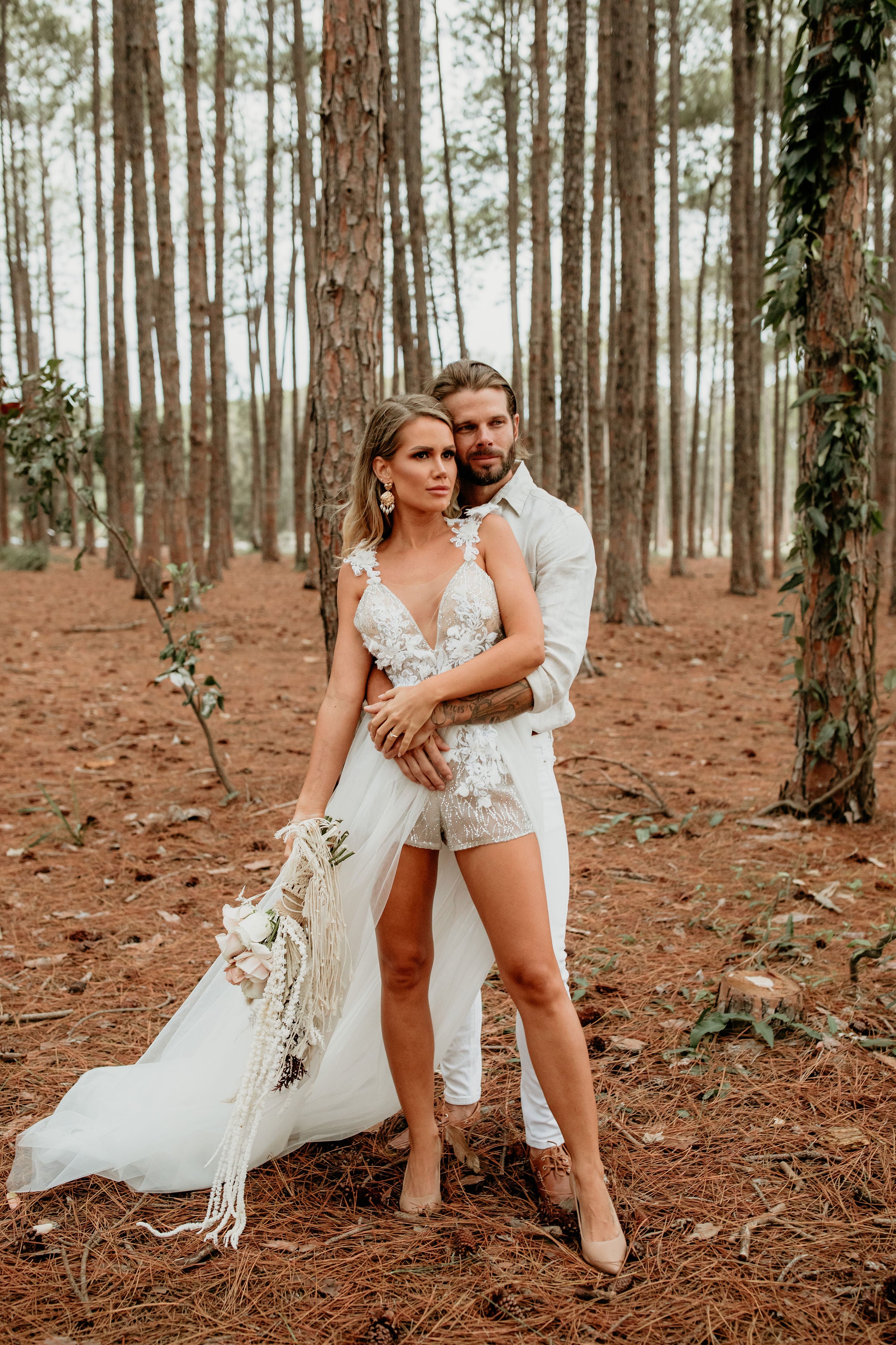 Couple in forest, woman in Honey Couture SOPHIA white tulle glitter bodysuit formal dress, Australian designer prom dress.