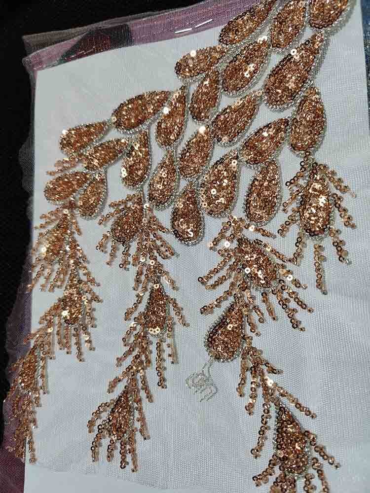 Intricate crystal beadwork on blush tulle fabric from the Honey Couture EDEN Gown, designed by an Australian designer for elegant occasions.