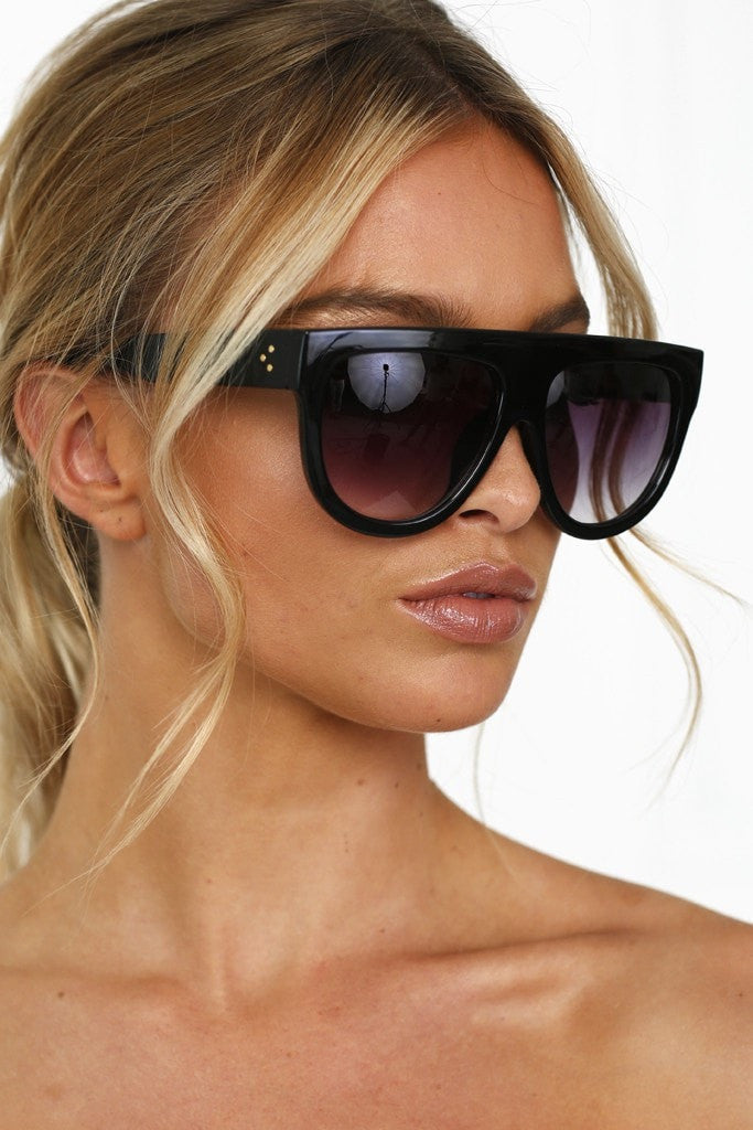 Model wearing Honey Couture's SELENA sunglasses with a black flat top design, ideal for formal and prom events. Designer's choice for glam look.