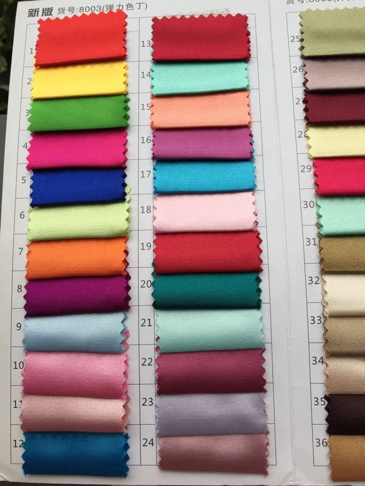 Fabric swatches in multiple vibrant colors displayed in a chart for clothing design selection.