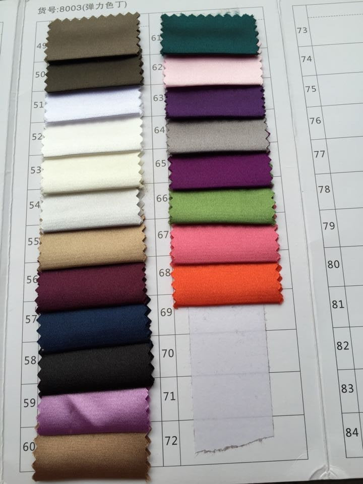 Fabric swatches in various colors including neutrals, pinks, purples, and greens, arranged on a grid sheet.