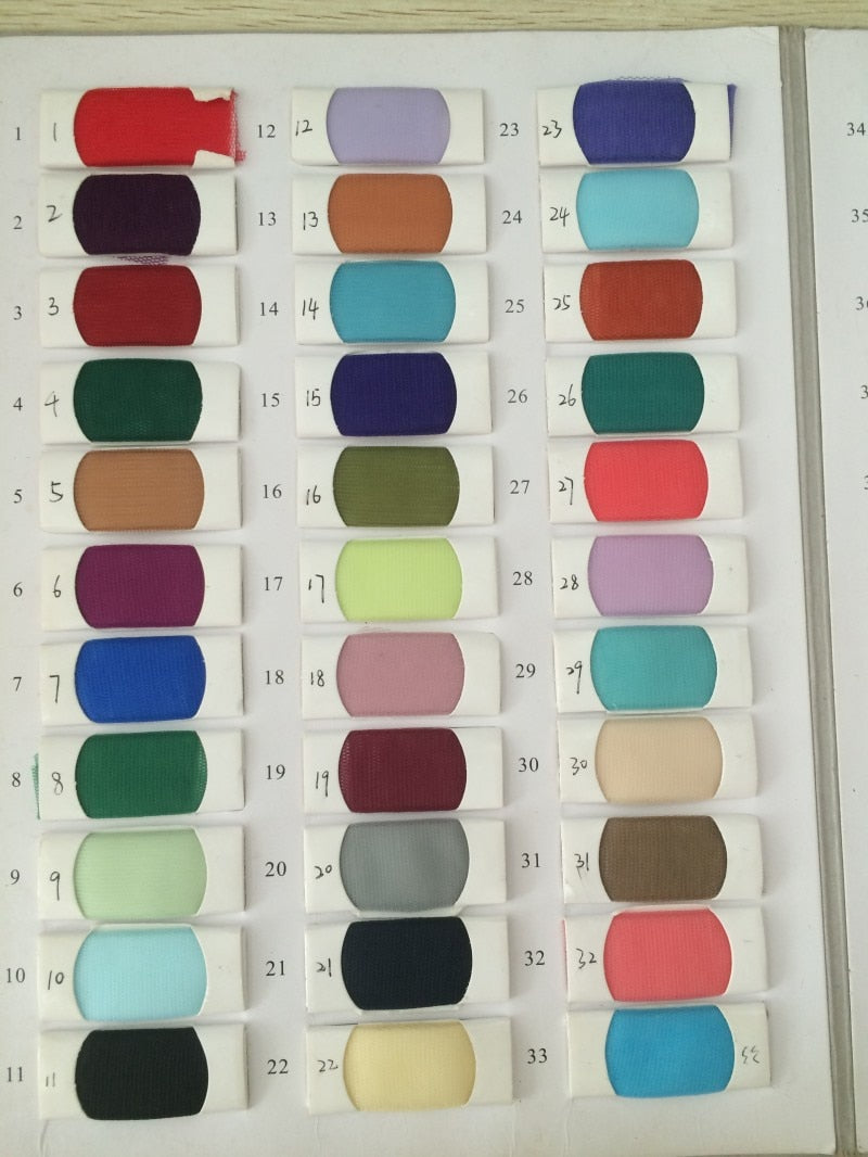 Color swatch chart with 36 fabric samples, each with unique numbers, displaying a range of red, blue, green, and neutral tones for fabric selection.