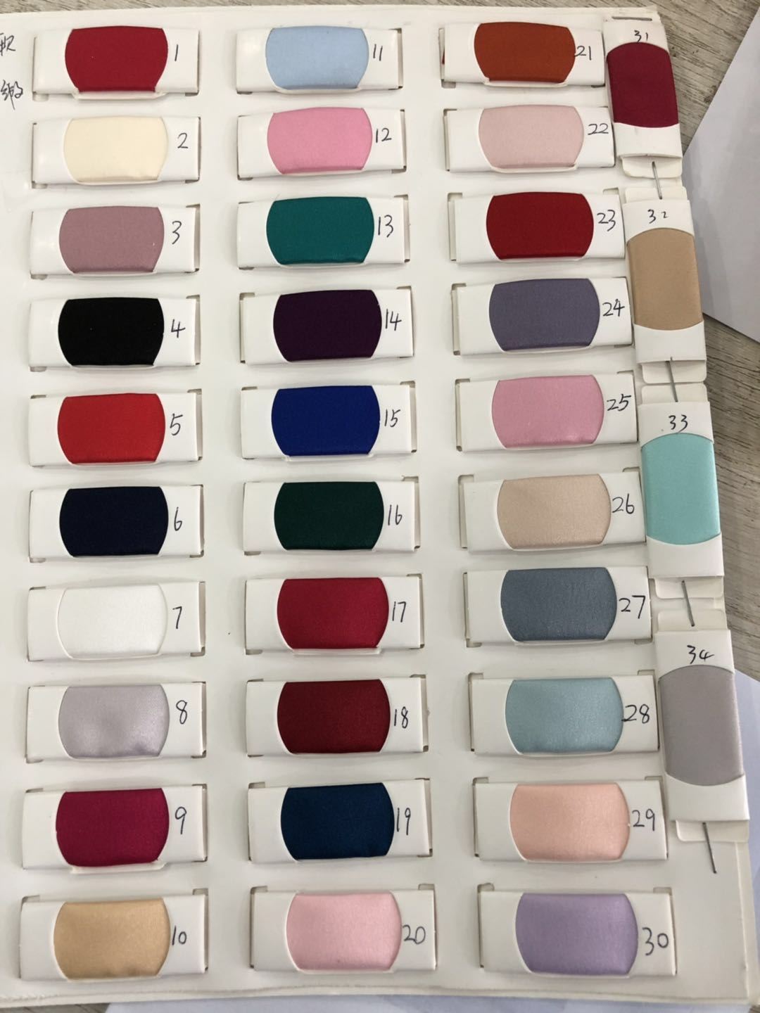 Color swatches featuring 36 diverse fabric samples for Honey Couture formal dresses, ideal for choosing bespoke dress options.
