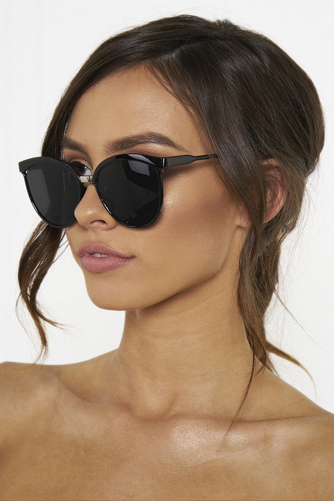Woman wearing Honey Couture MAGGIE Reflective Sunglasses with black frame, chic accessory for summer style from Australian formal store.