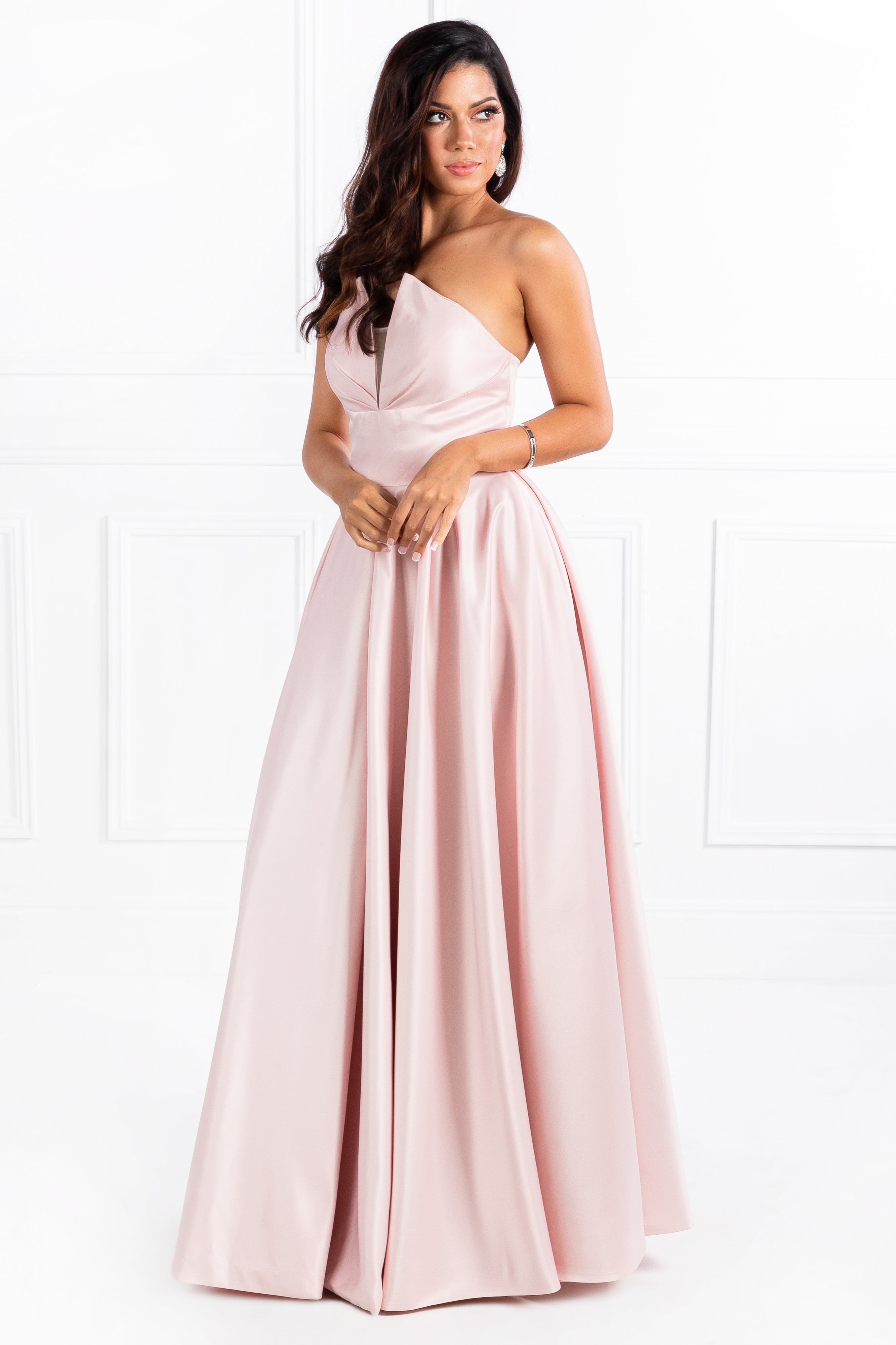 Model wearing a strapless pink evening gown, featuring elegant design suitable for prom or formal events, by Australian Designer Honey Couture.