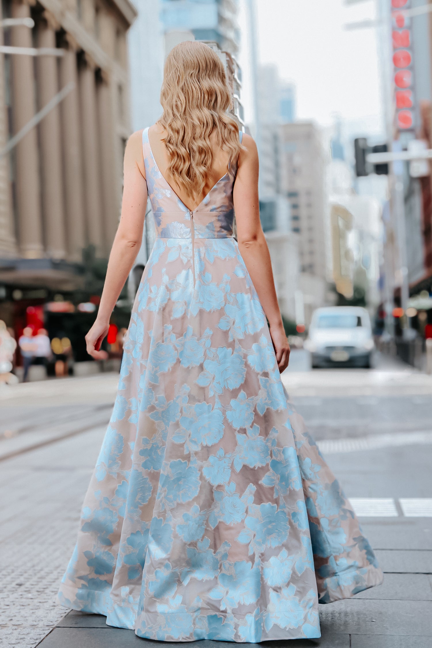 TINA HOLLY COUTURE T1120 pastel blue floral strapless ballgown seen from the back, city street scene, Brisbane to Gold Coast, Australia.