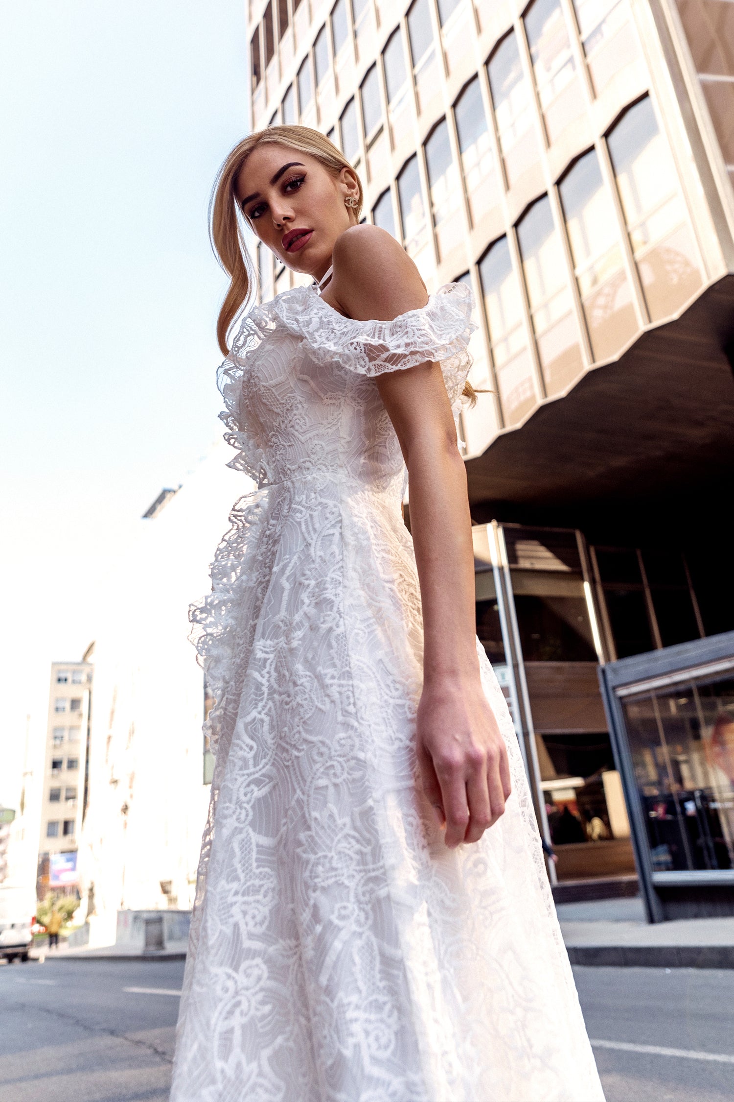 TINA HOLLY COUTURE TK011W off-shoulder lace wedding dress, A-line silhouette, city background, Brisbane to Gold Coast