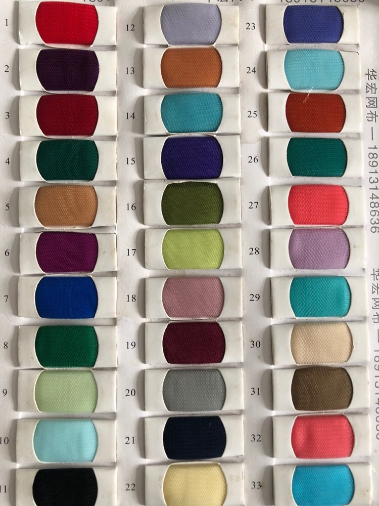Fabric color swatches with 34 options, showcasing a vibrant spectrum from reds to blues, purples, and greens for customization.