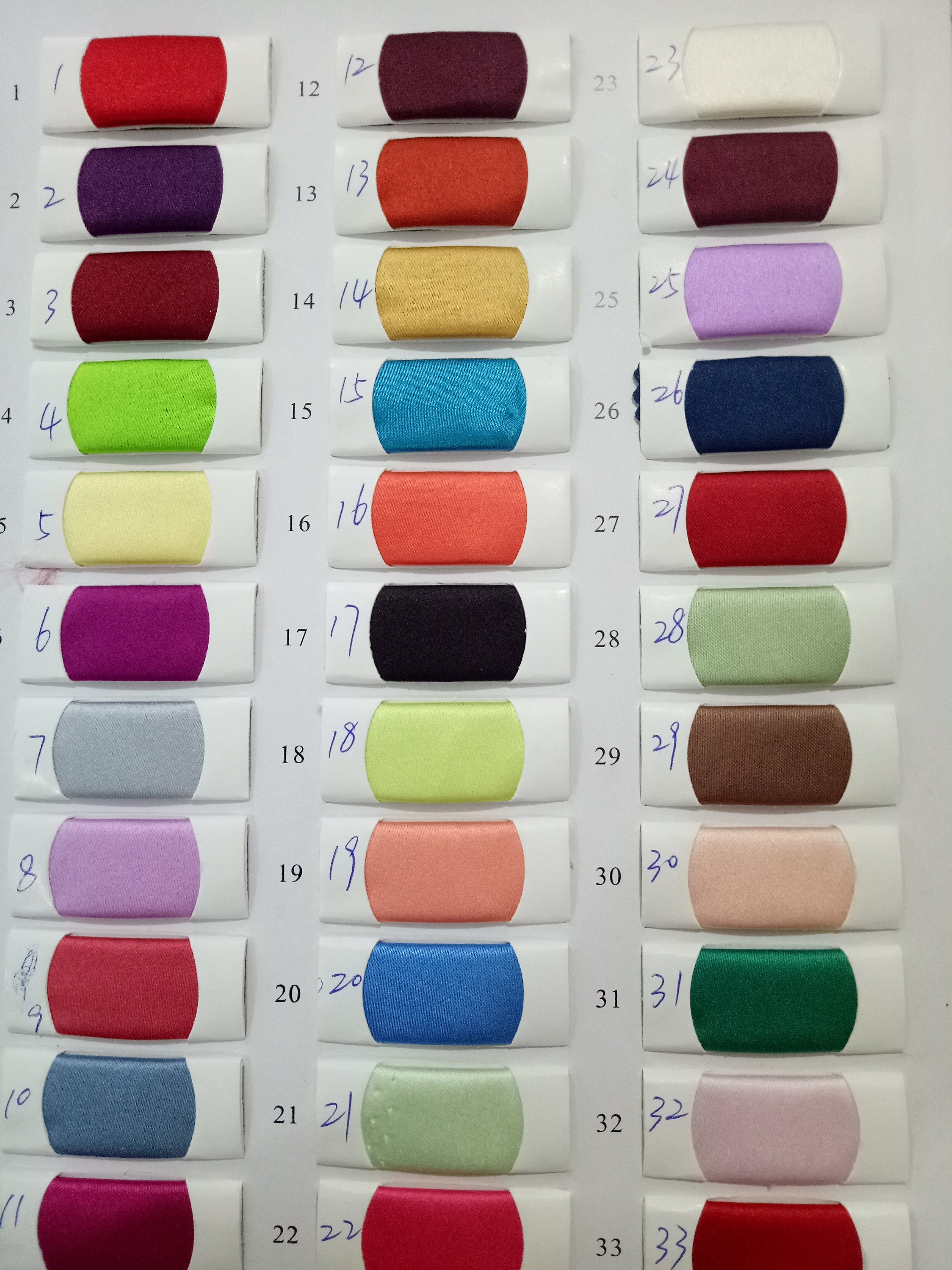 Fabric color swatches arranged in a grid, showcasing various shades for textile selection.