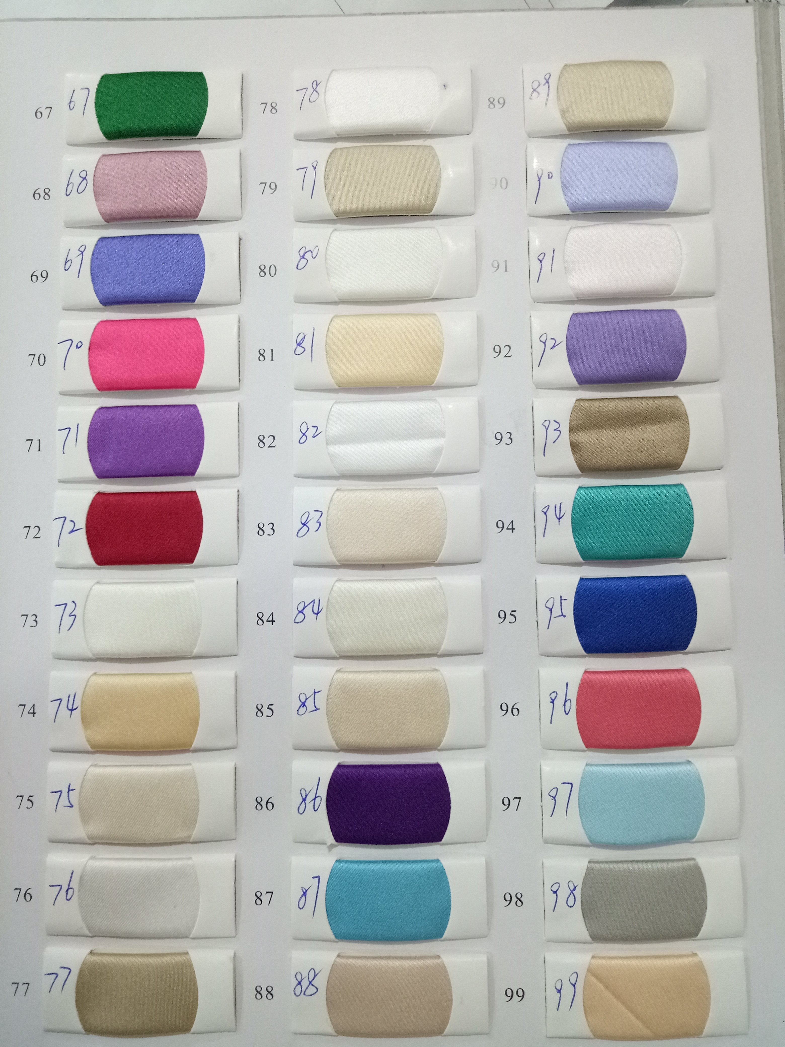 Fabric color swatches labeled with numbers, displaying a variety of shades including green, pink, purple, red, blue, and beige.