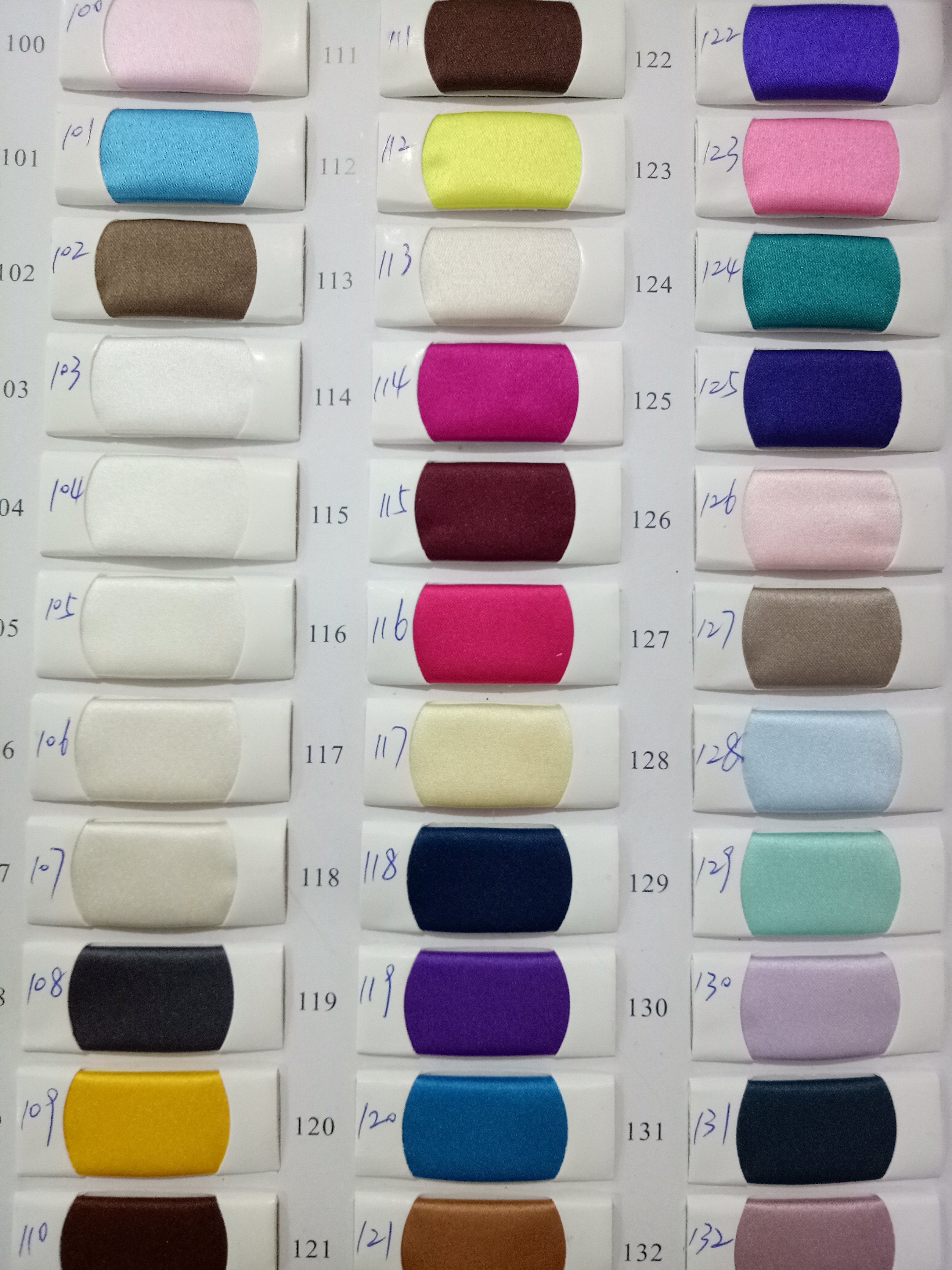 Assorted fabric color swatches used for formal dresses, showcasing various options by Honey Couture, an Australian Designer.