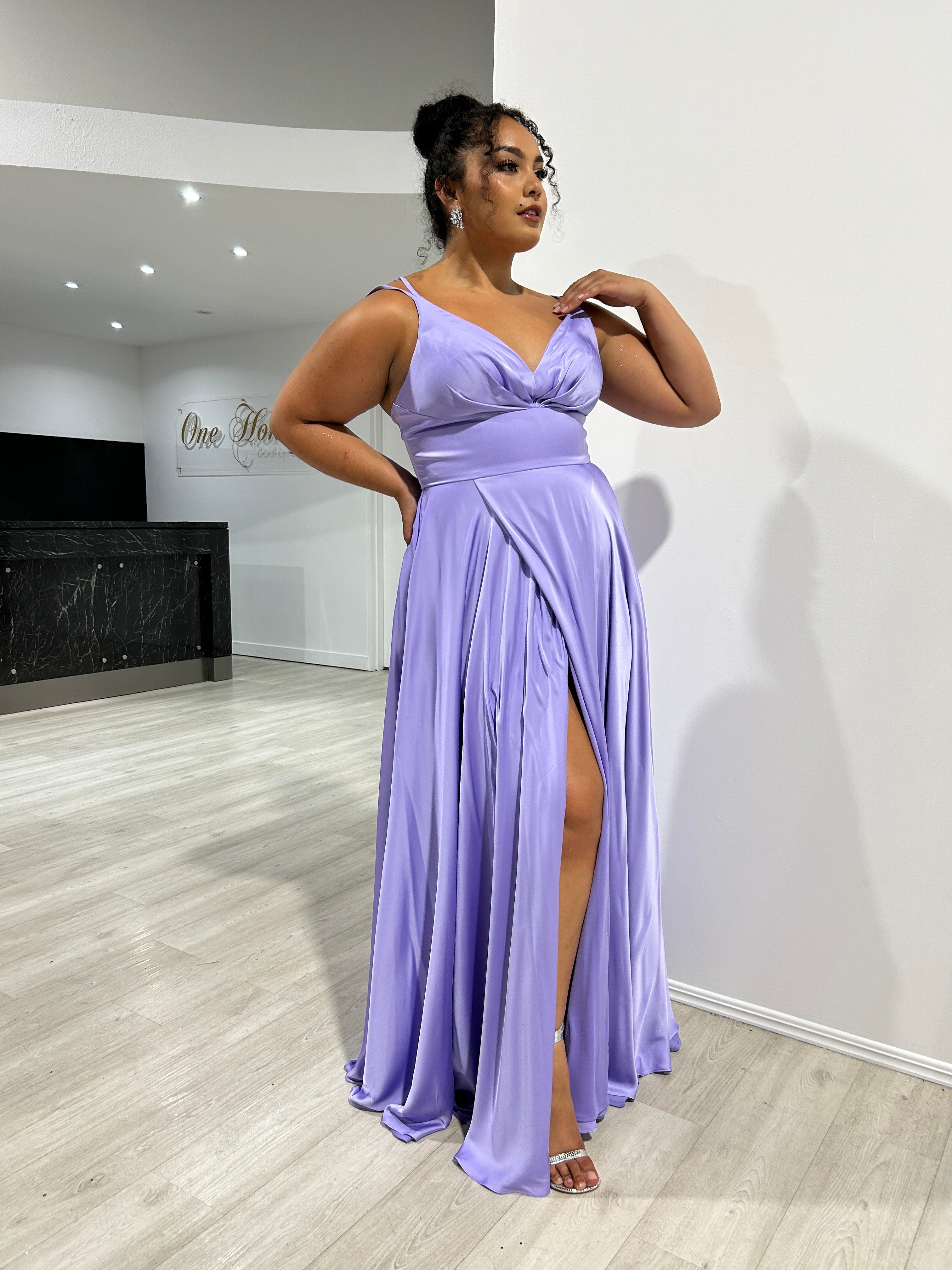 Woman in Honey Couture ROSALIA Curve Lavender Silky A-Line Formal Dress with leg split, perfect for prom or evening. Australian Designer.