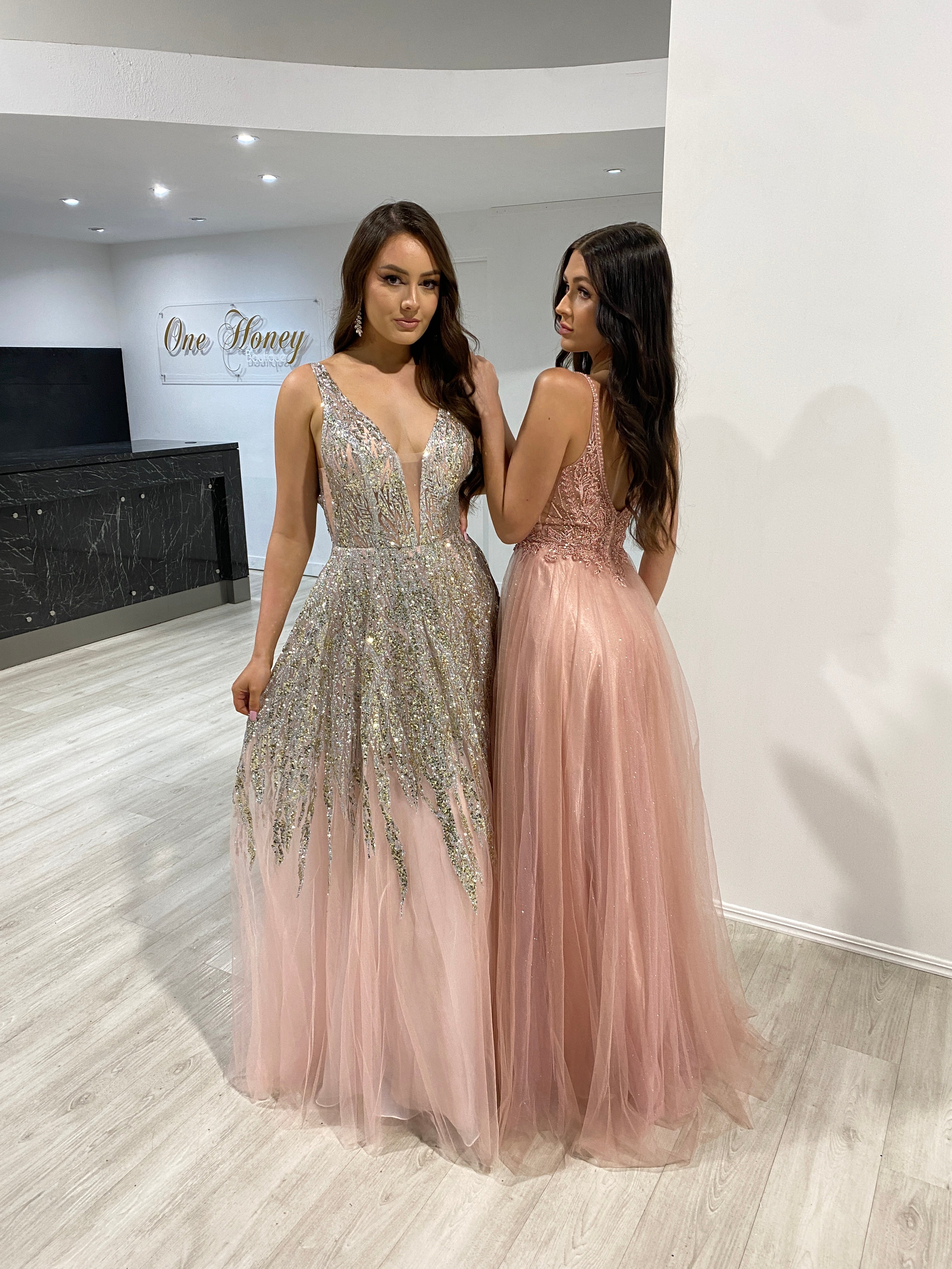 Women wearing elegant glitter tulle A-line prom and formal dresses with plunging necklines, showcasing shimmering skirts. Brisbane to Gold Coast