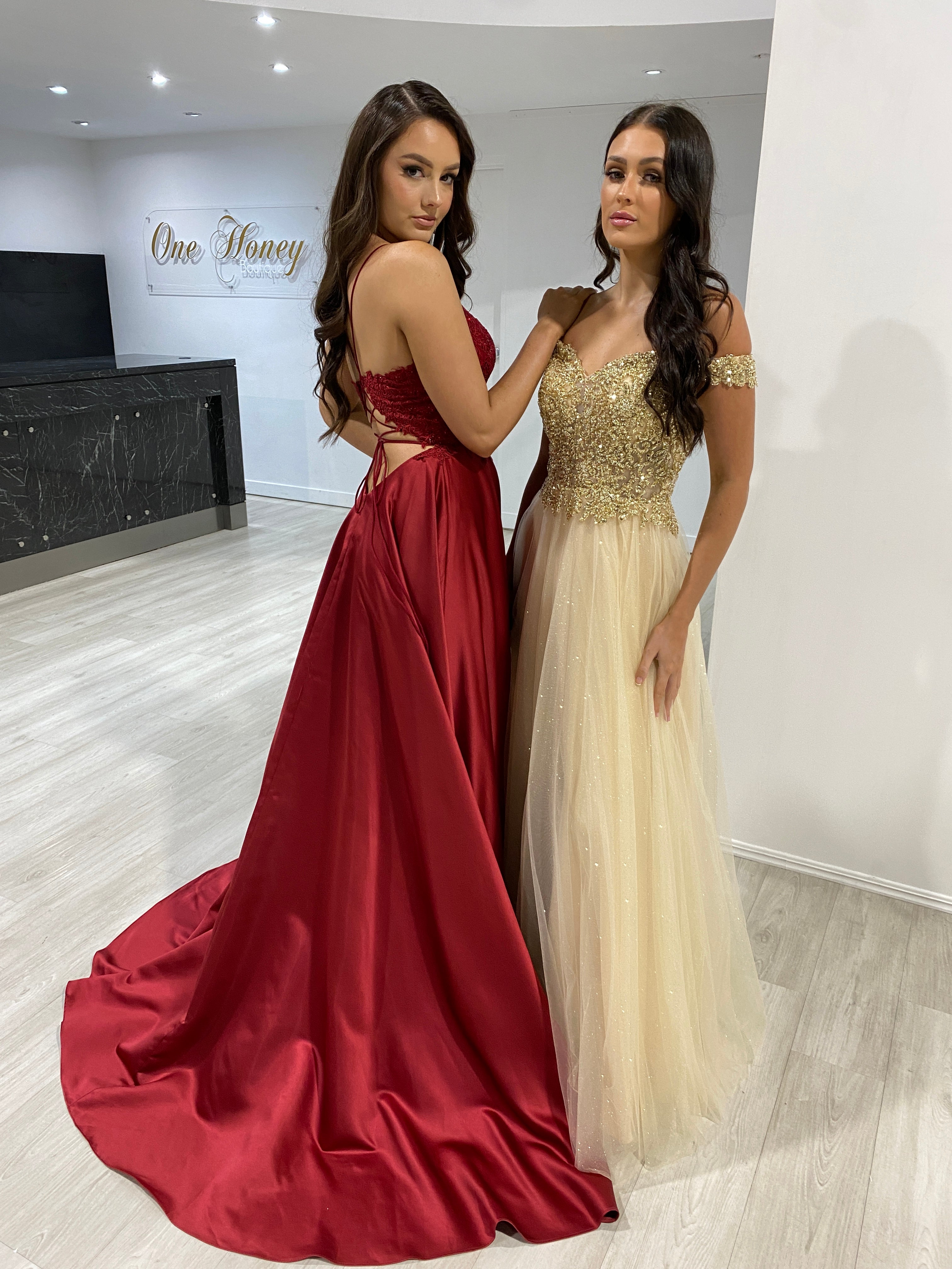 Two women in elegant gowns, one wearing the Honey Couture MATISSE Burgundy Satin A Line Corset Back Dress, perfect for formal events.