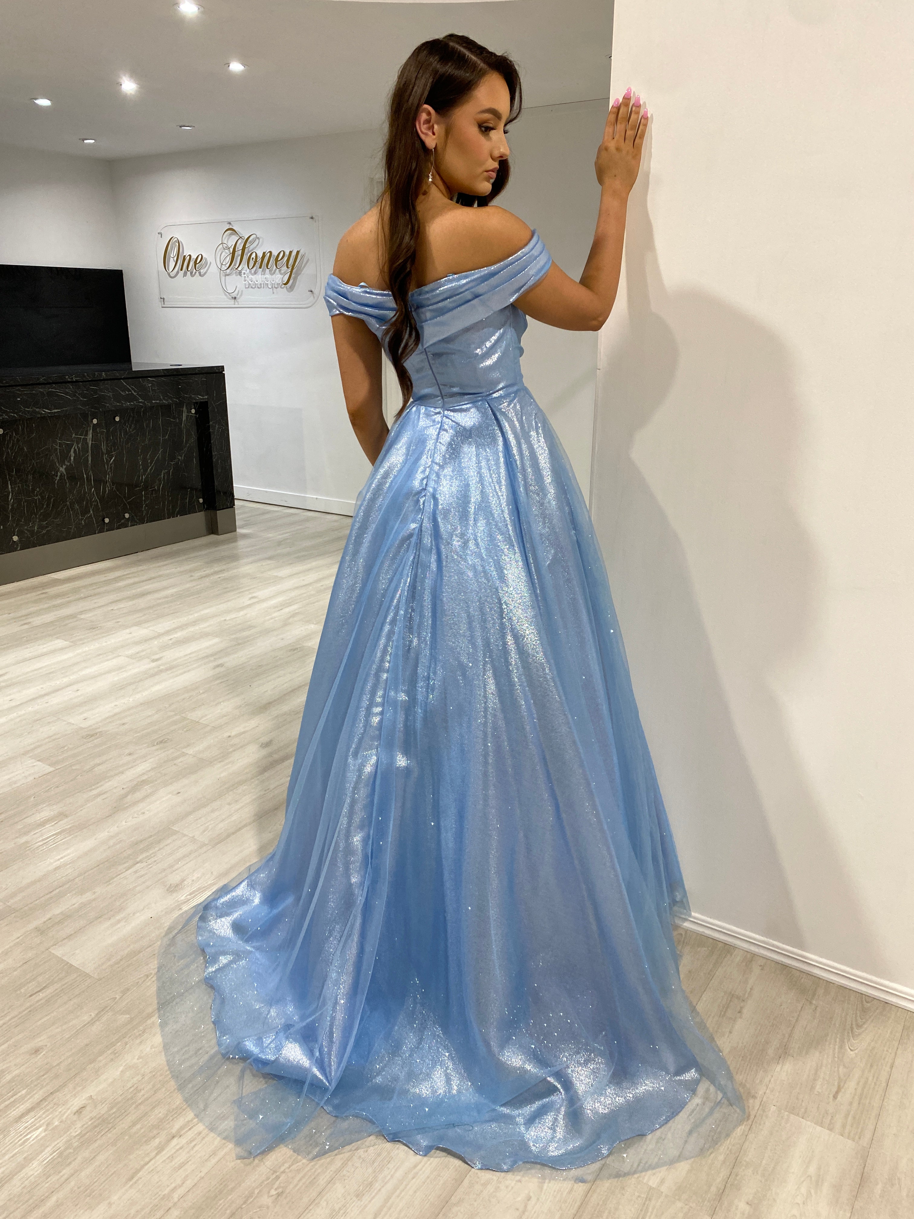 ARIANA Shimmer Off Shoulder Ballgown featuring an elegant sweetheart neckline and glitter metallic fabric. Evening gown Brisbane to Gold Coast.